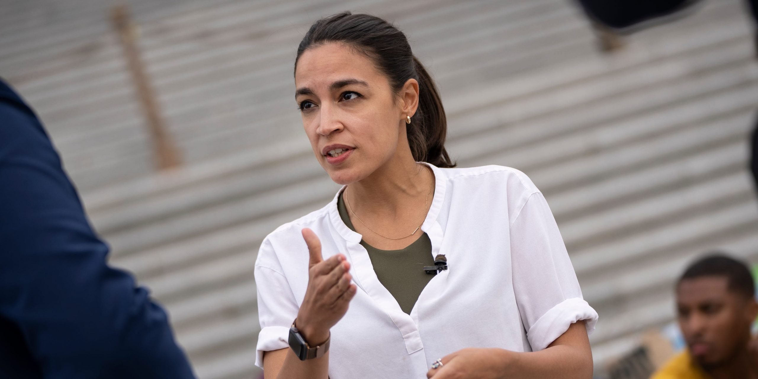 Alexandria Ocasio Cortez gestures at the Capitol