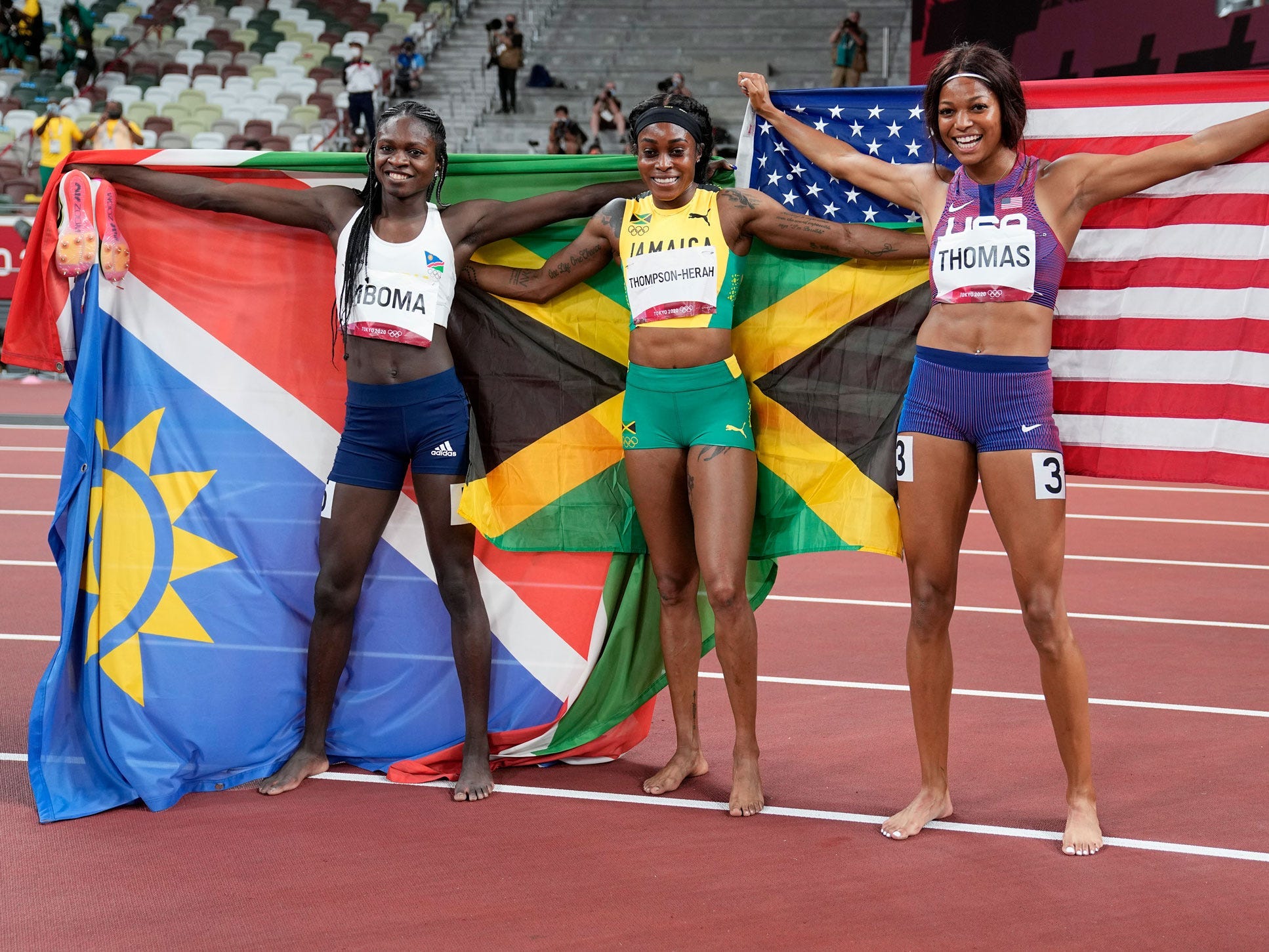 Namibia's Christine Mboma celebrates with Jamaica's Elaine Thompson-Herah and American Gabrielle Thomas.