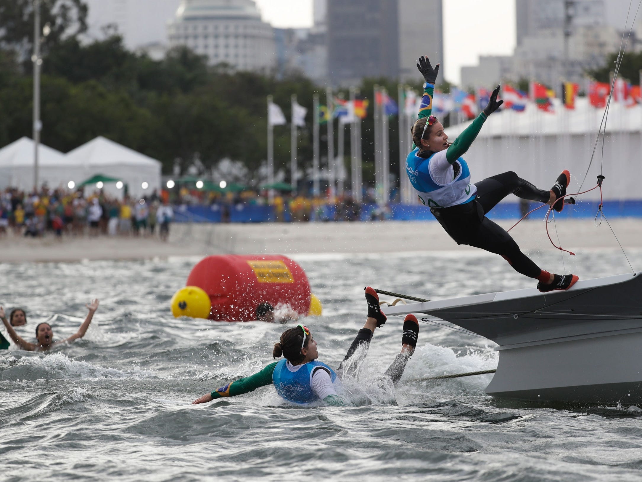 Brazil's Kahena Kunze and Martine Grael jump to the water after winning gold at Rio 2016.