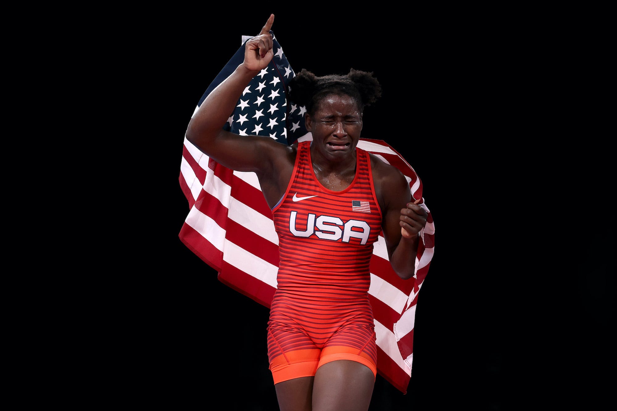 American wrestler Tamyra Mensah-Stock celebrates her Olympic gold medal match win over Blessing Oborududu, of Nigeria, during the women's freestyle event at the Olympic Games in Tokyo.