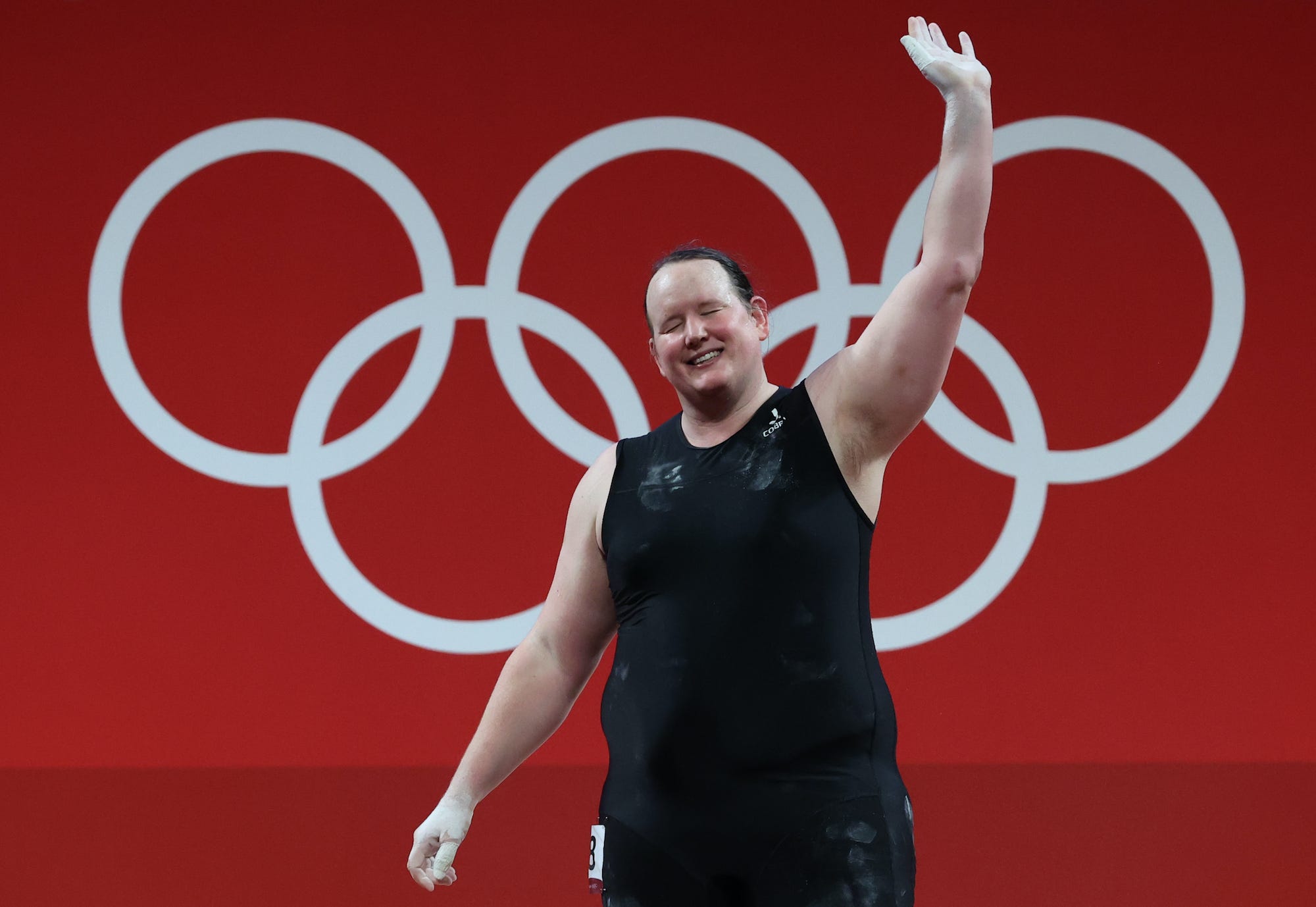 Laurel Hubbard, of New Zealand, waves during the weightlifting event at the Olympic Games in Tokyo.