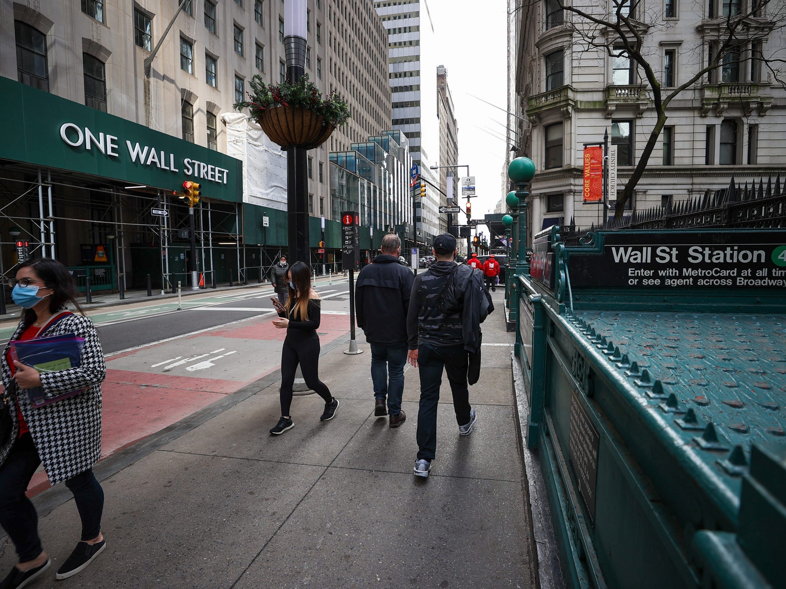 People are seen by the Wall Street Station during COVID-19 pandemic in New York City, United States on March 25, 2021.