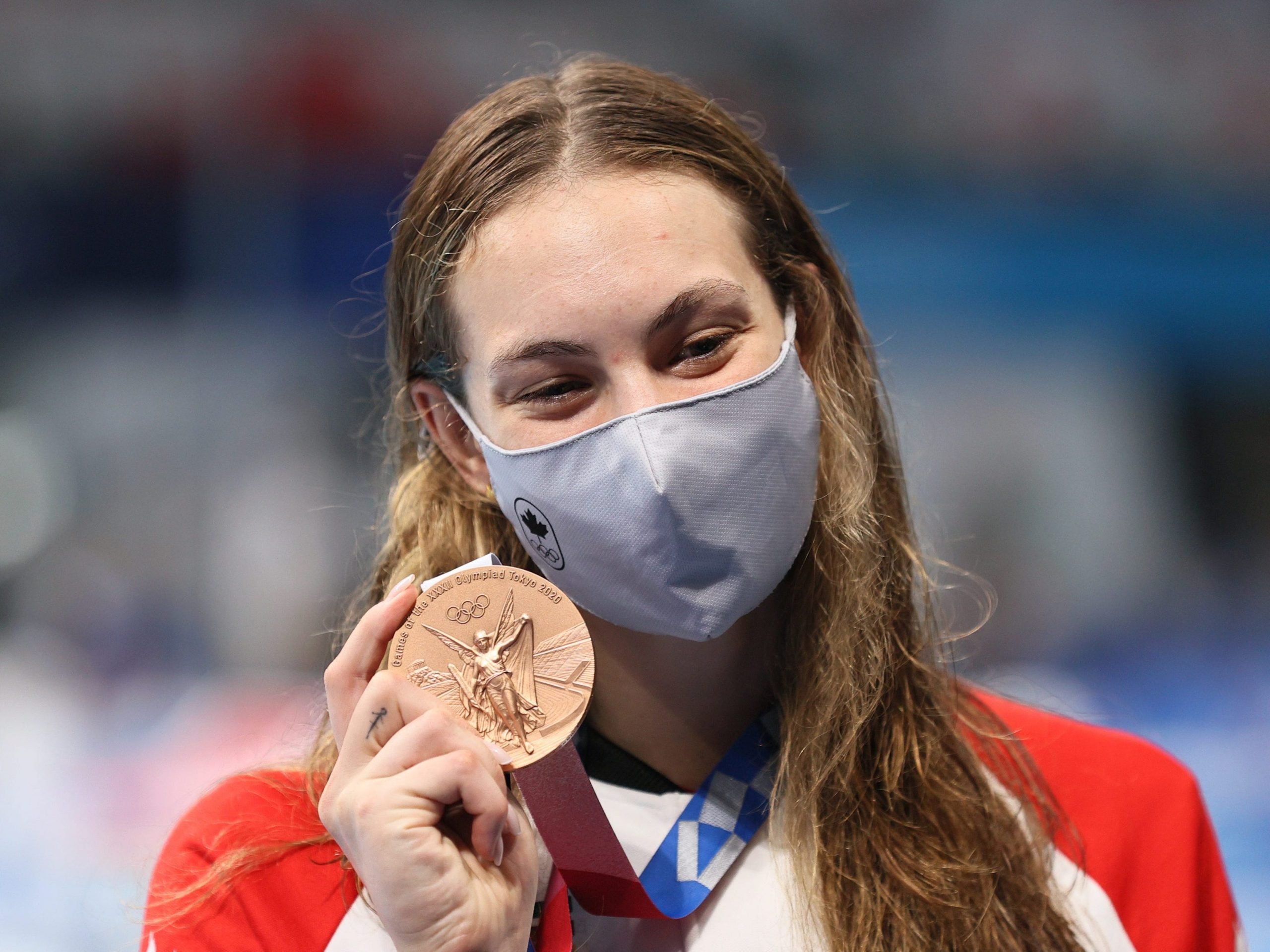 Bronze medallist Penny Oleksiak of Canada poses with her medal during the victory ceremony for the ladies' 200m freestyle final at Tokyo Aquatics Centre