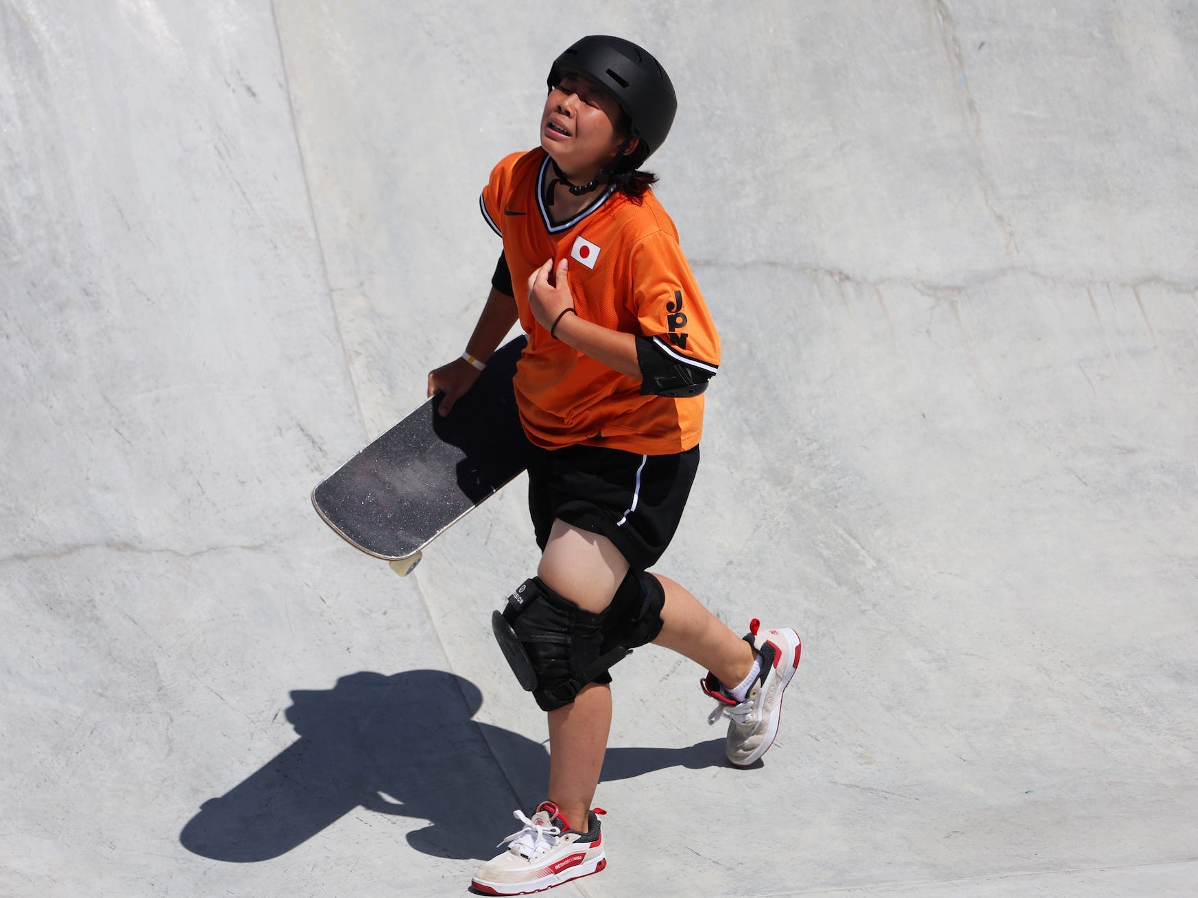 Misugu Okamoto looks upset walking out of the Tokyo Olympic skateboarding park final.