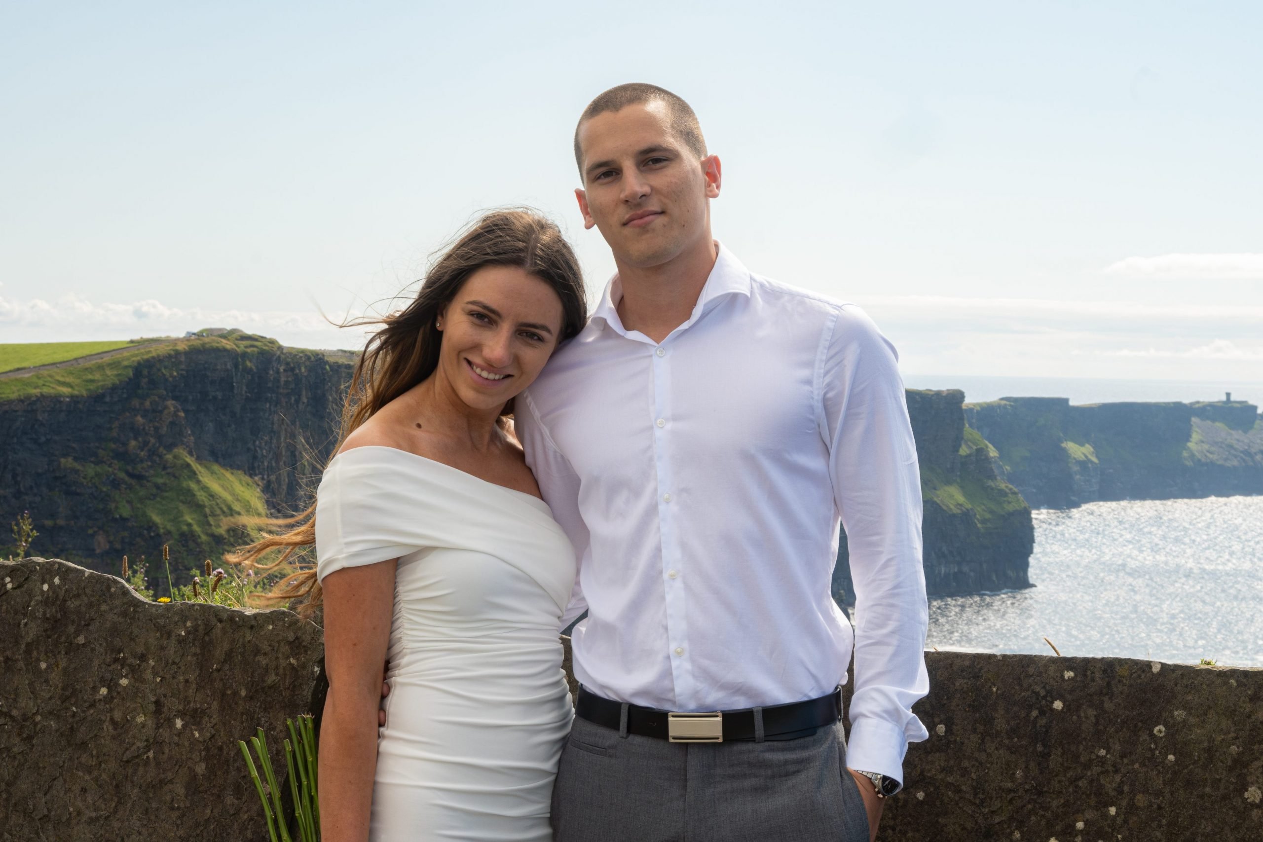 Andela and Mateo Rako pose for wedding pictures taken by Kevin Hennessy on the Cliffs of Moher, Ireland.