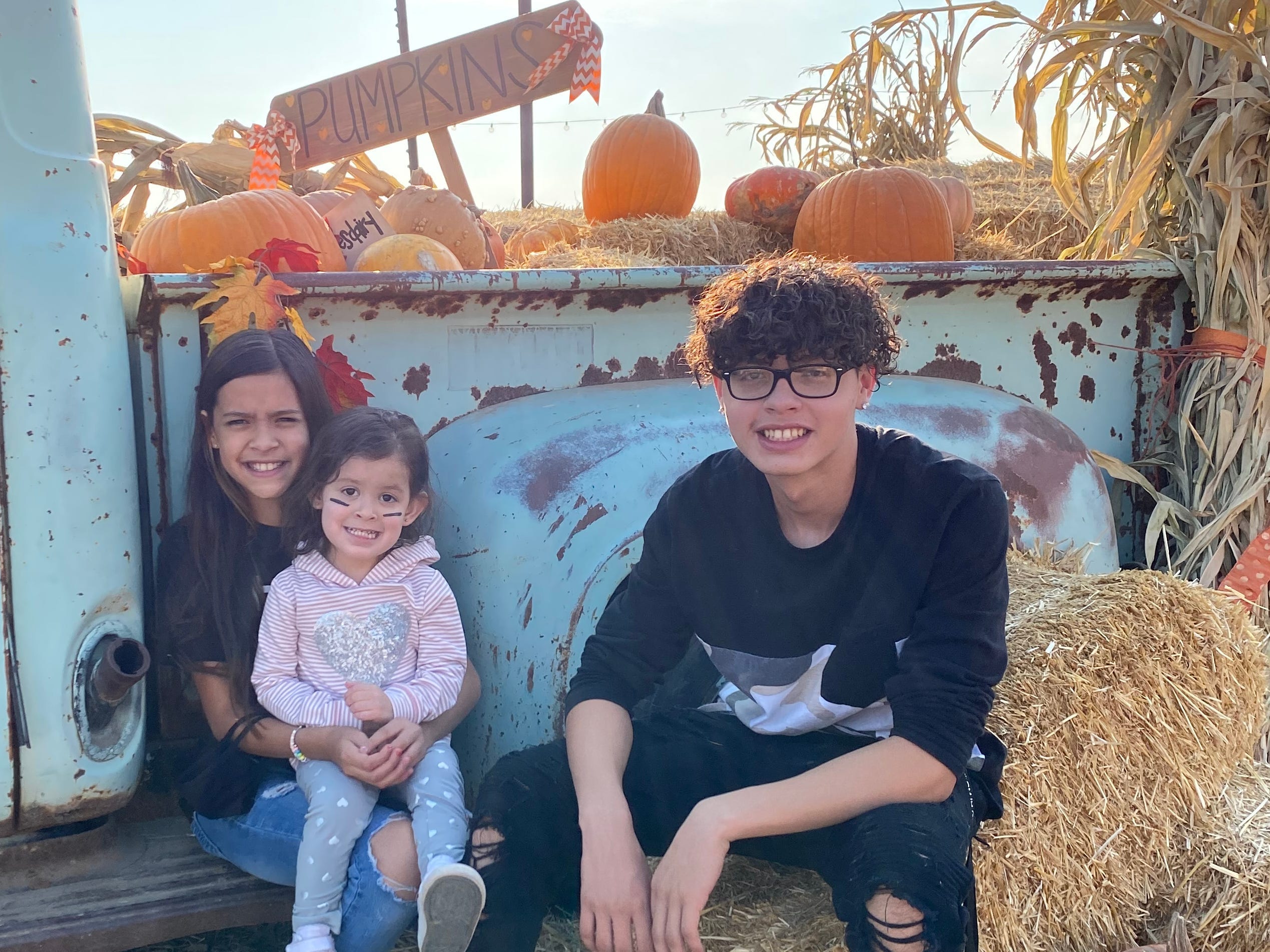 abie and his sisters at a pumpkin patch, before covid-19