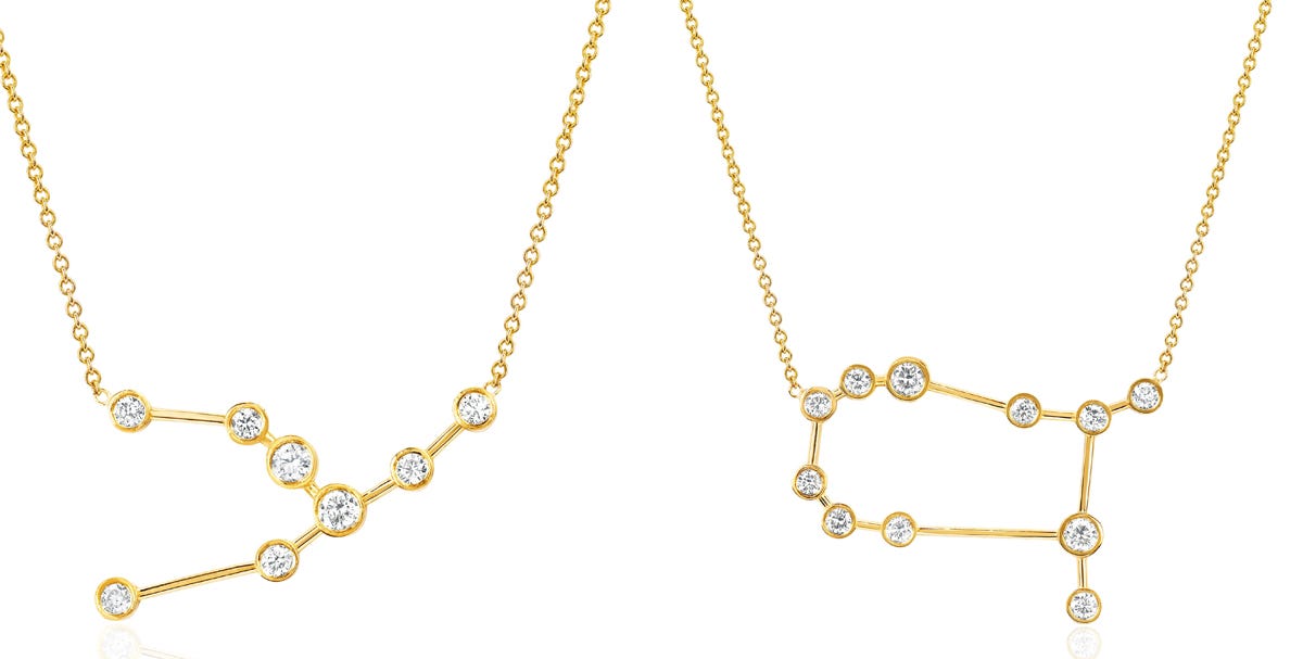 Two gold necklaces that form the shape of constellations against a white backdrop.