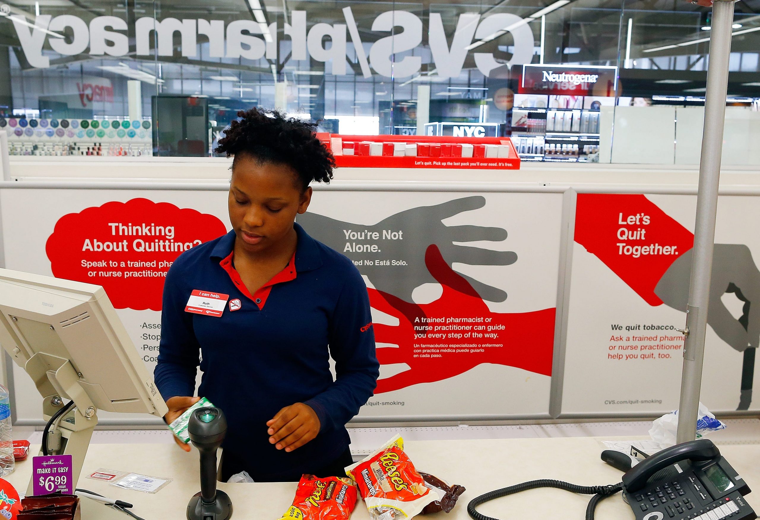 CVS cashier Ruth Jean, 19, of Dorchester rings up a customer at CVS in Boston, Massachusetts