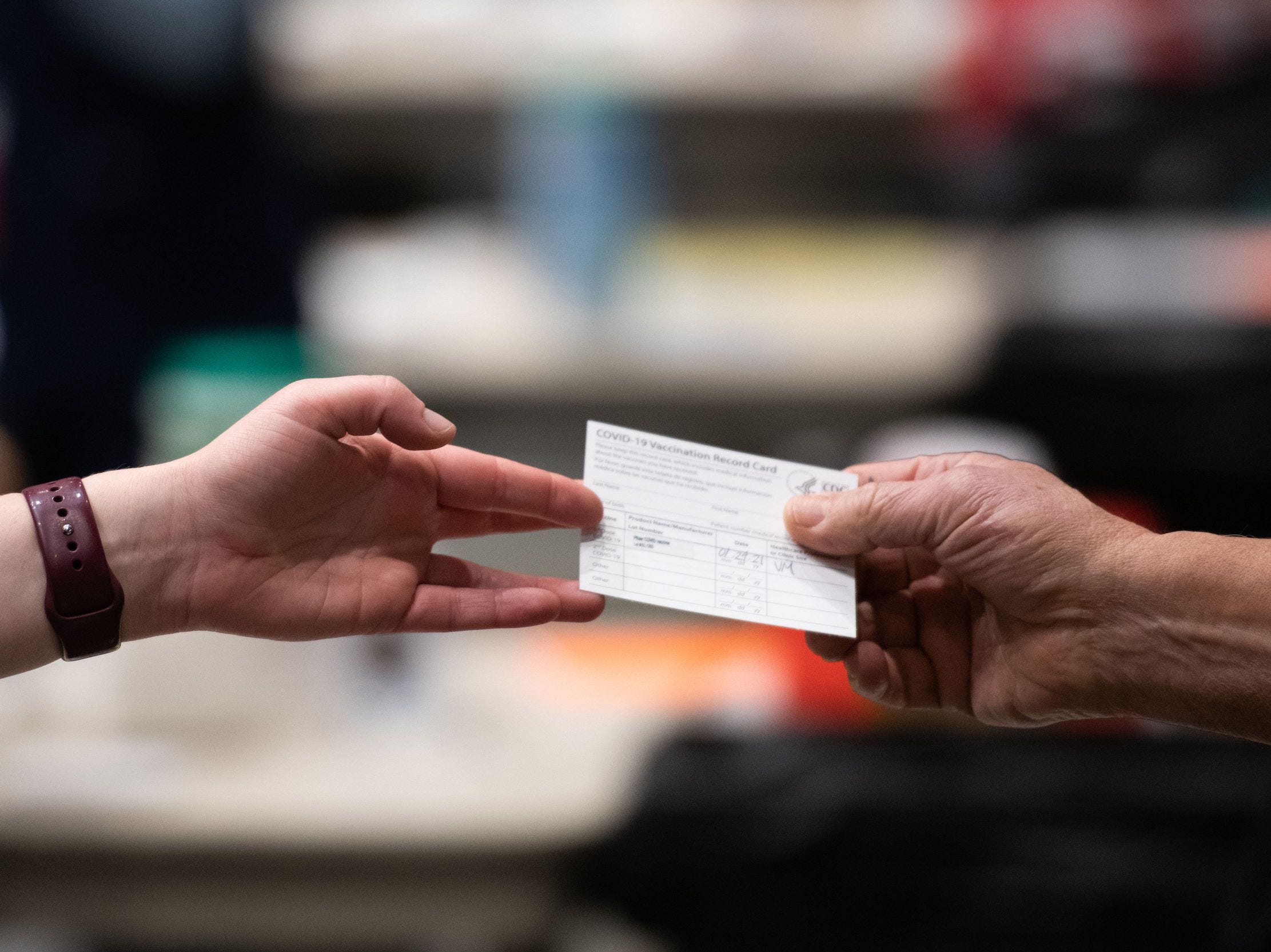 Person receives vaccine card stating they've had first dose of Pfizer COVID-19 vaccine