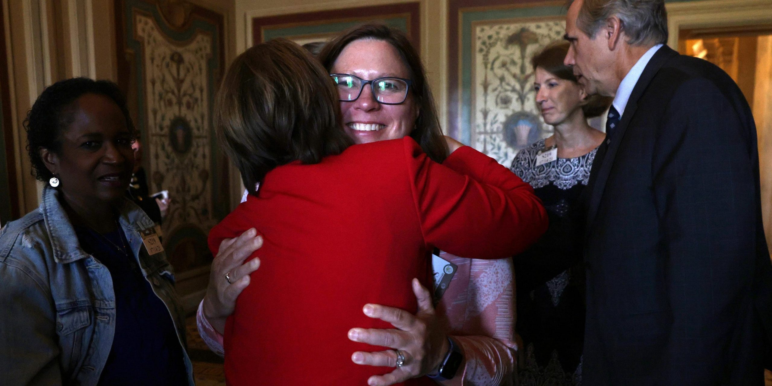 Texas State Rep. Julie Johnson, one of the two legislators currently in Portugal, hugs US Sen. Amy Klobuchar (D-MN) after a meeting between the senator and members of Texas House Democratic Caucus at the US Capitol July 14, 2021 in Washington, DC.