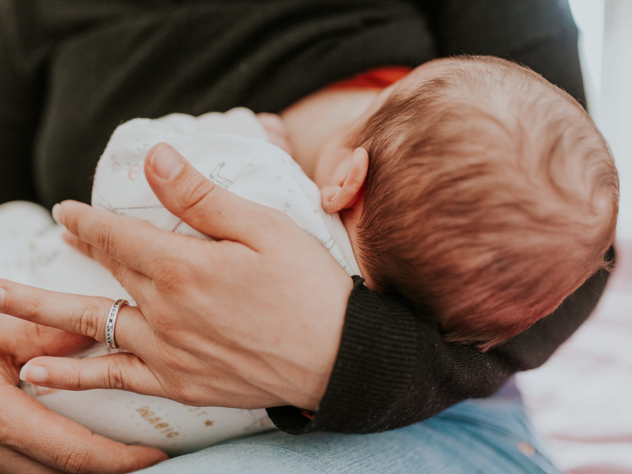 Baby being held by mom