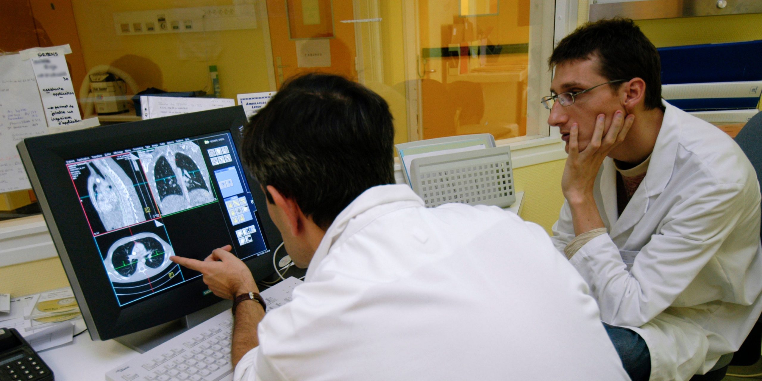 Stock photo of doctors analyzing a lung cancer scan.