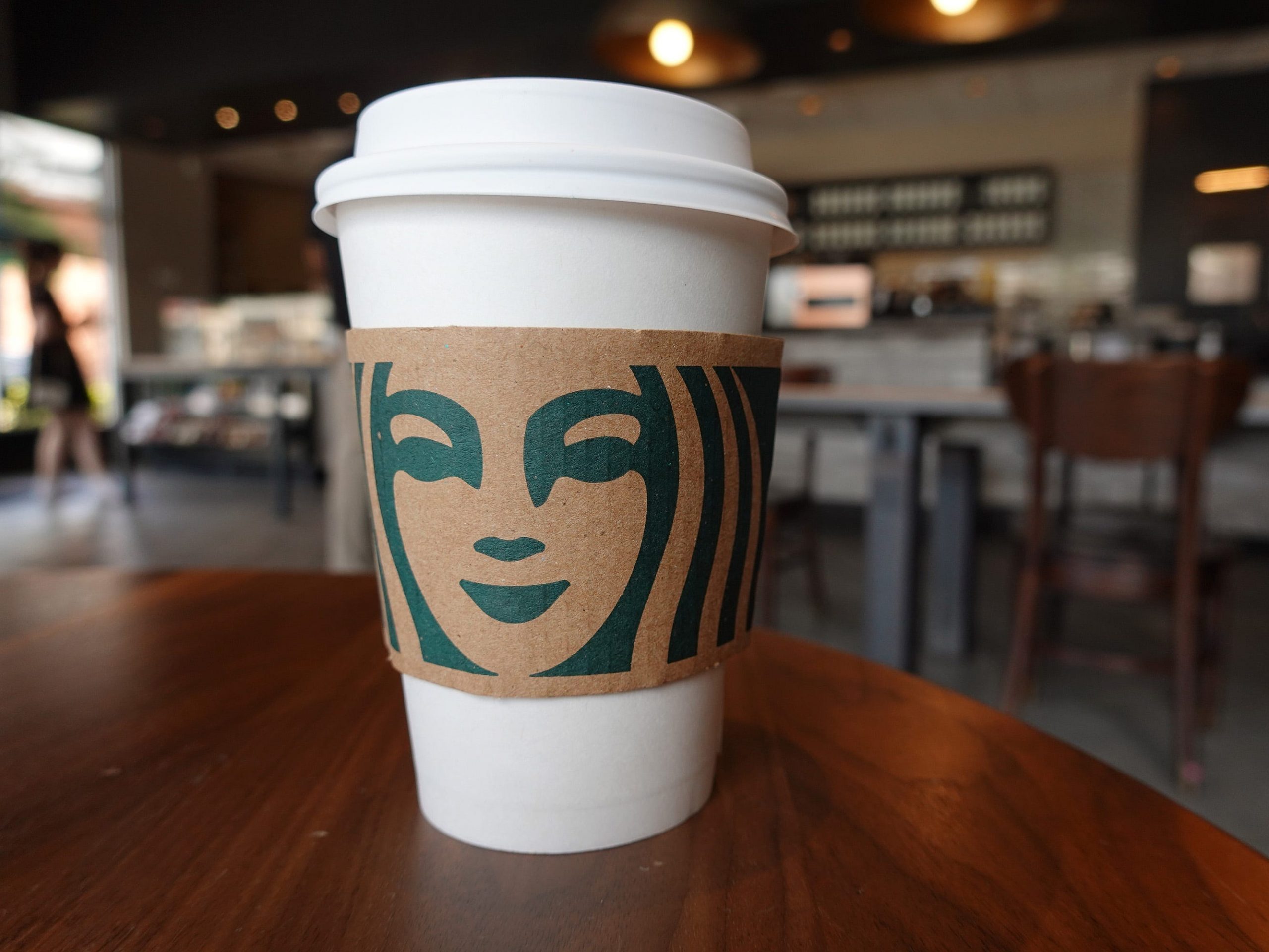 starbucks cup sits on a table