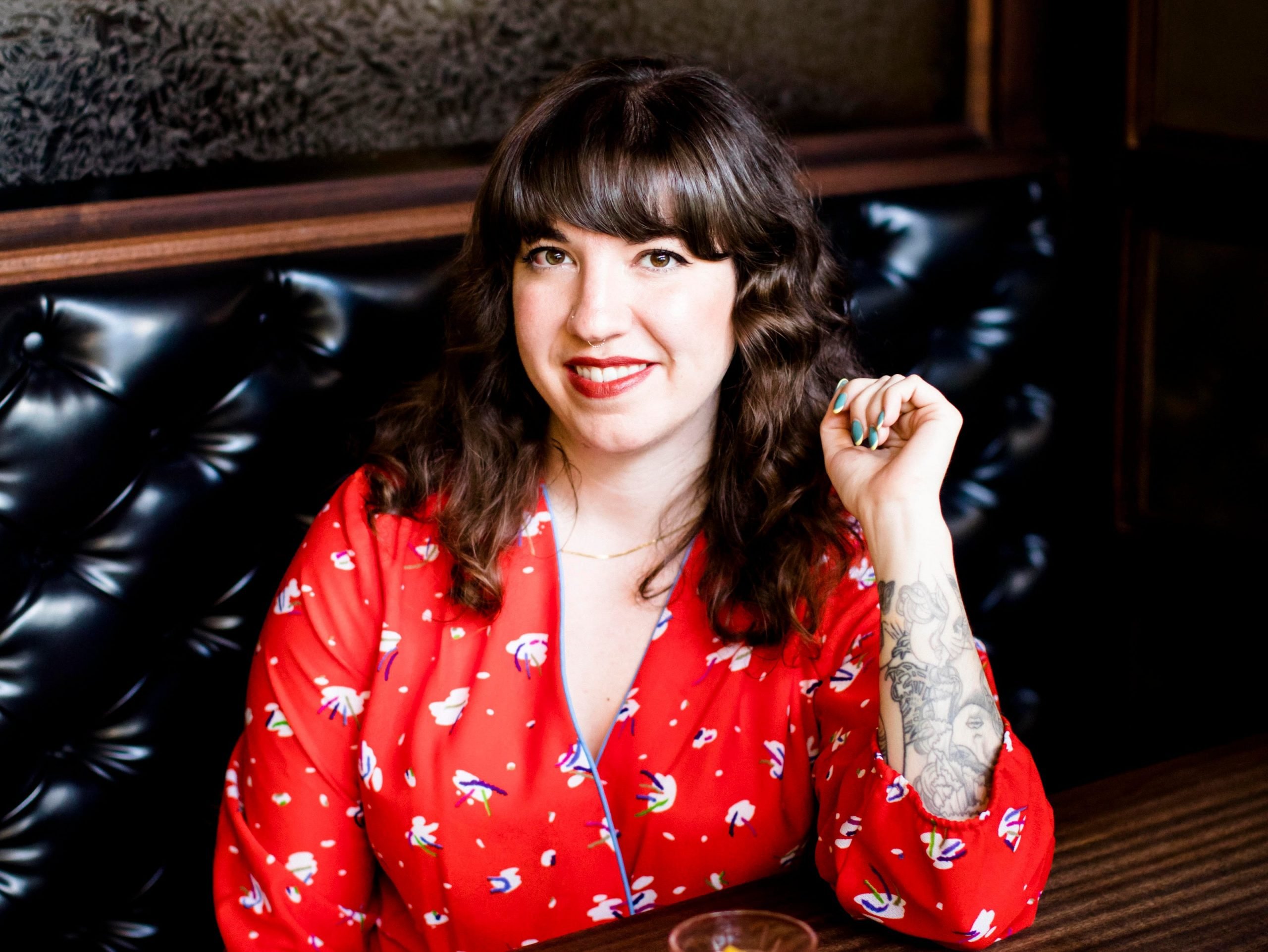 Kathryn Kulczyk, owner and general manager of The Alembic in San Francisco, sits at her restaurant