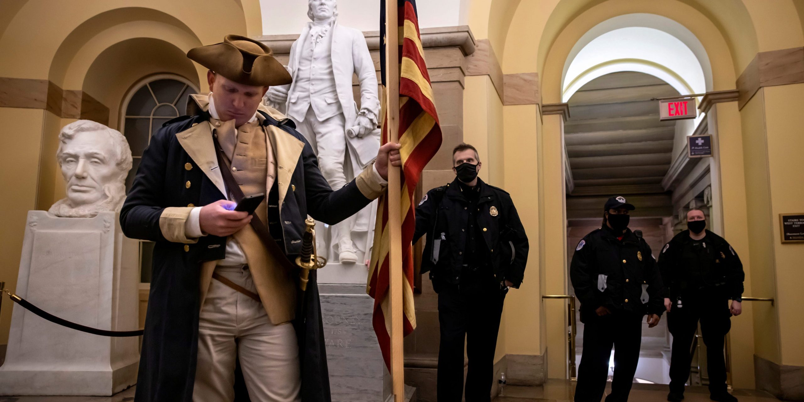 Man dressed as george washington at the US Capitol in front of police officers