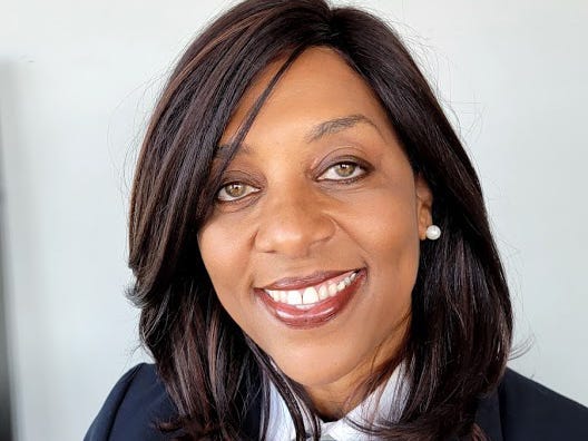 Wells Fargo's Ruth Jacks poses in her head shot wearing a blue pinstripe dress shirt.