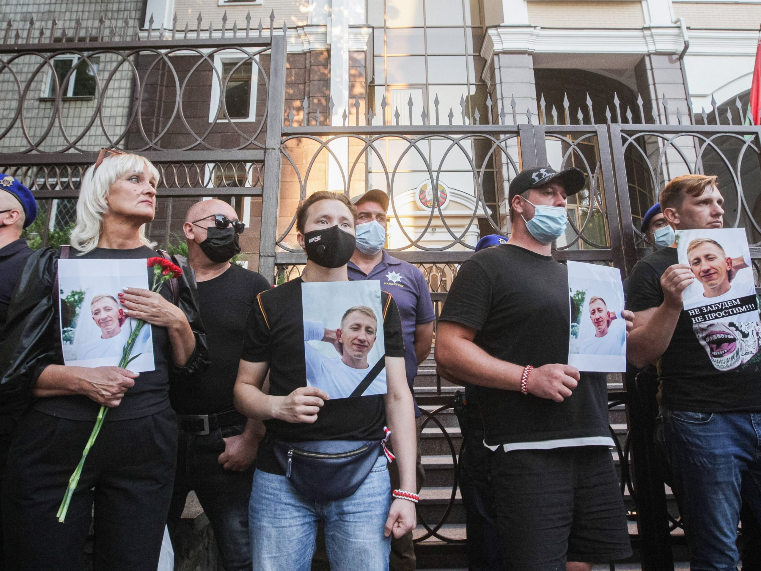 Activists hold portraits of Belarusian opposition activist and Head of the Belarusian House in Ukraine Vitaly Shishov during a protest in his memory outside the Belarus Embassy in Kiev, August 03, 2021.