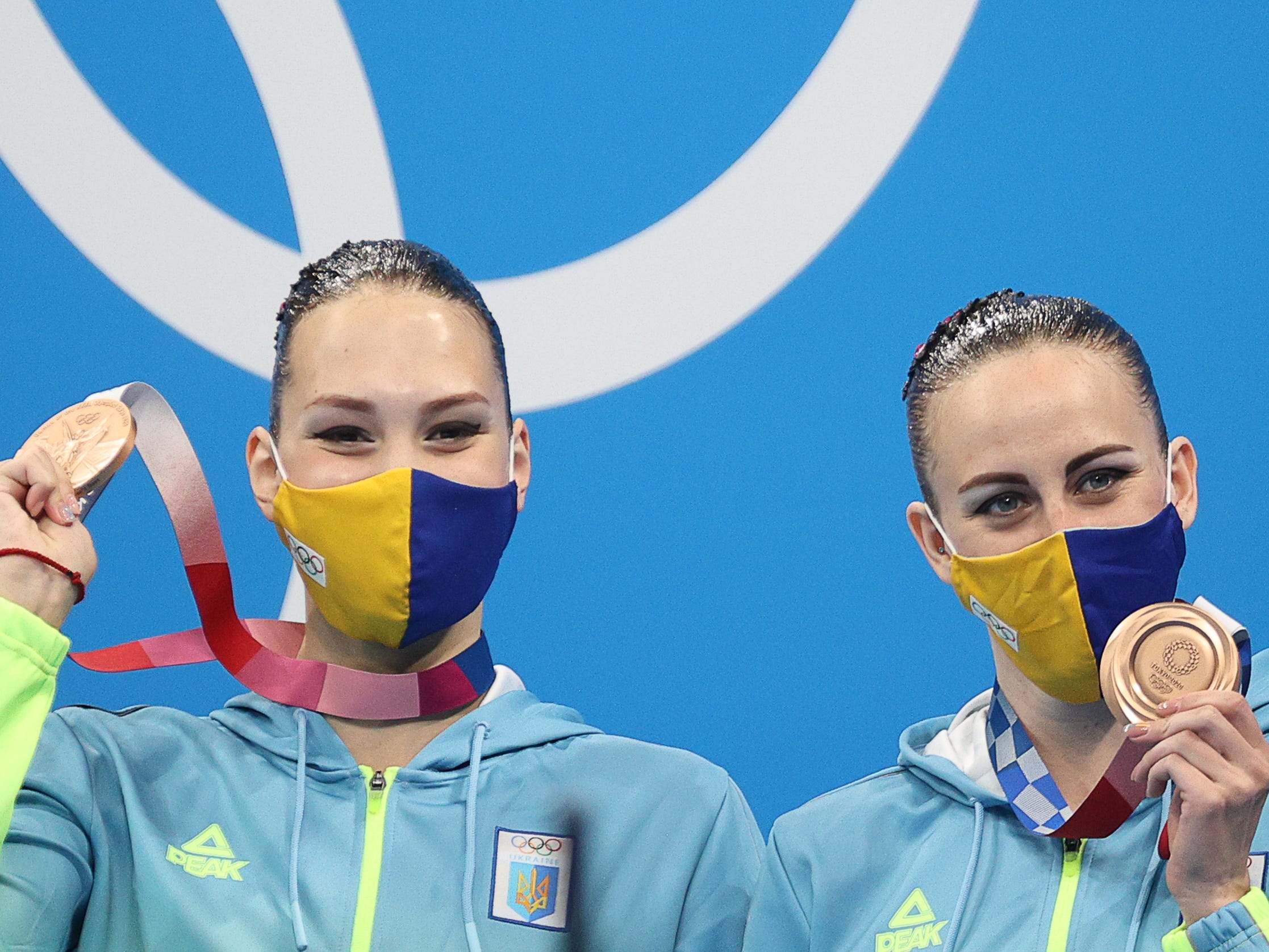 ronze medalists Marta Fiedina and Anastasiya Savchuk of Ukraine at an award ceremony for the artistic swimming duet free routine at the 2020 Summer Olympic Games