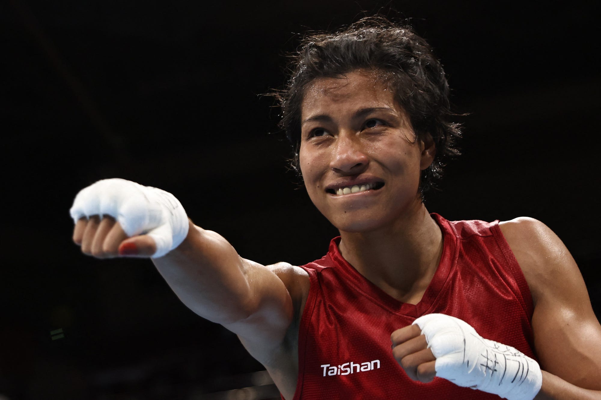 India's Lovlina Borgohain celebrates after winning against Chinese Taipei's Nien-Chin Chen after their women's welter (64-69kg) quarter-final boxing match during the Tokyo 2020 Olympic Games at the Kokugikan Arena