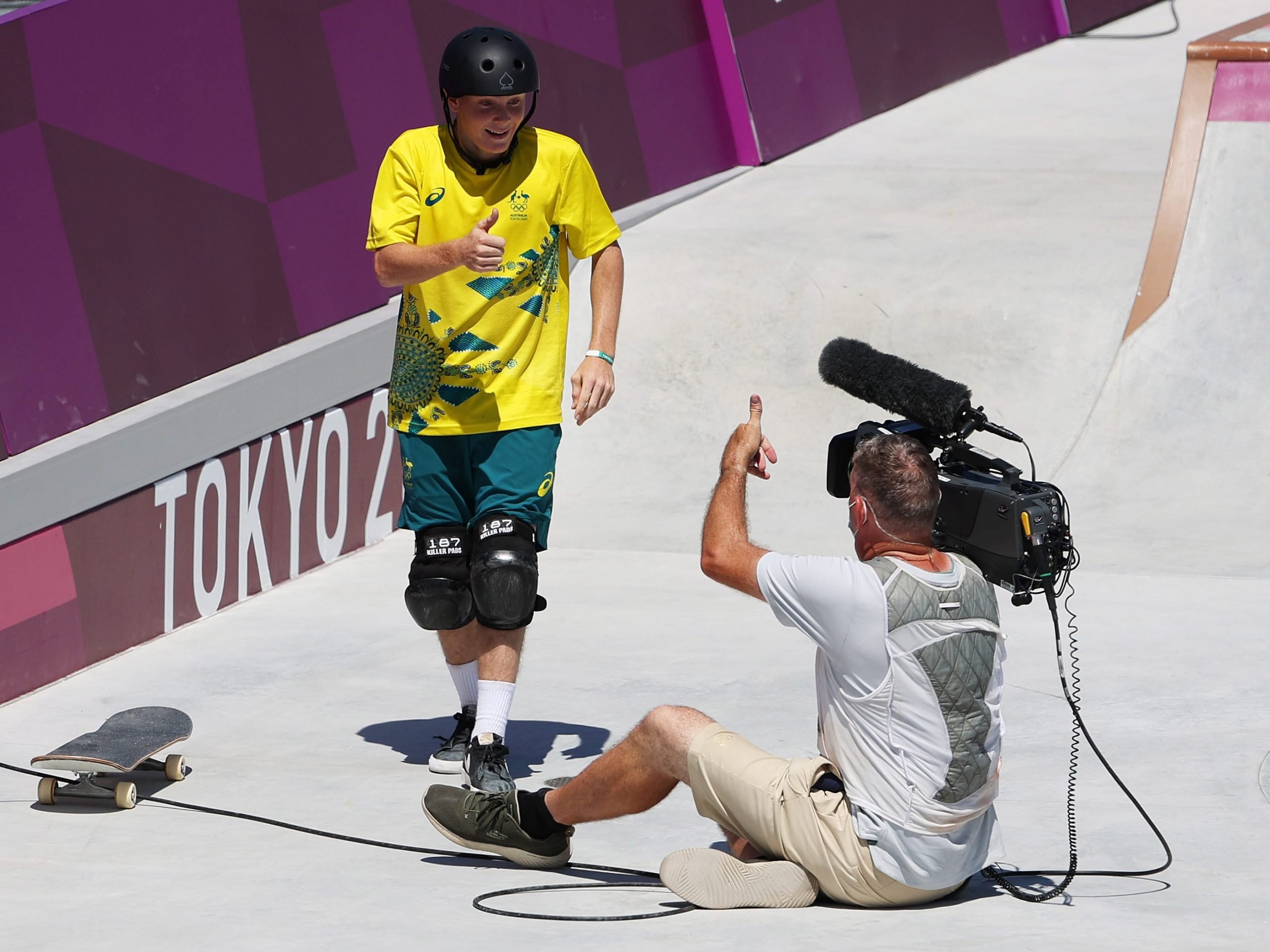 Kieran Woolley of Team Australia crashes into a TV cameraman