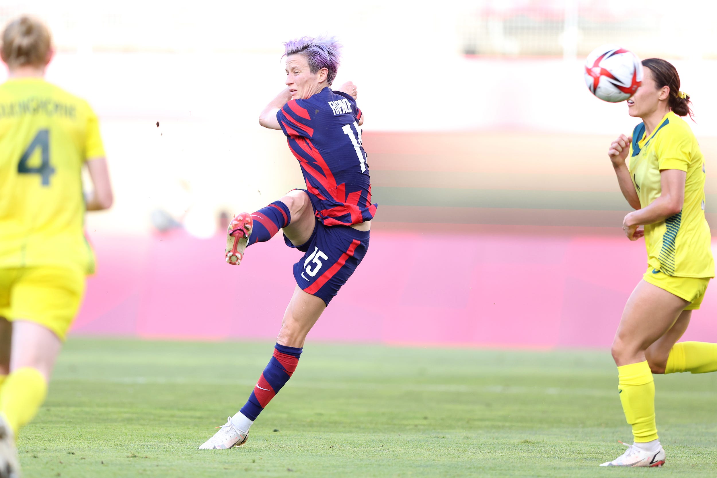 Megan Rapinoe volleys a ball into the goal.
