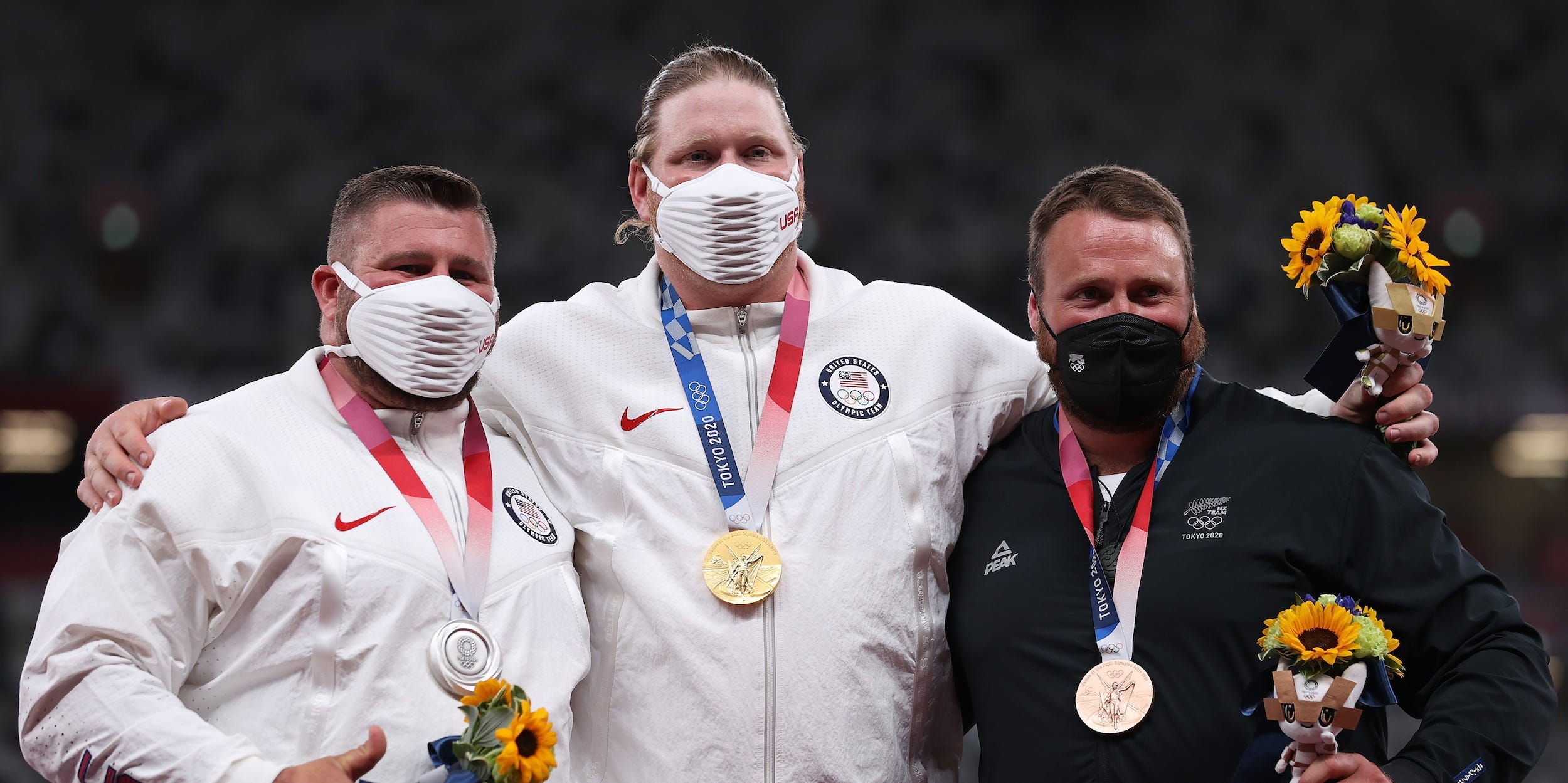 Silver medalist Joe Kovacs of Team United States, gold medalist Ryan Crouser of Team United States and bronze medalist Tom Walsh of Team New Zealand stand on the podium during the medal ceremony for the Men’s shot put on day thirteen of the Tokyo 2020 Olympic Games at Olympic Stadium on August 05, 2021 in Tokyo, Japan.