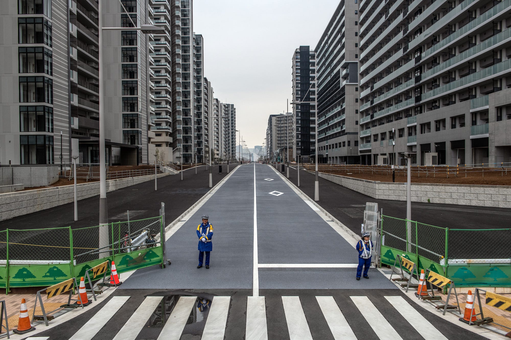 Security guards stand at an entrance to the Tokyo 2020 Olympics Athletes Village