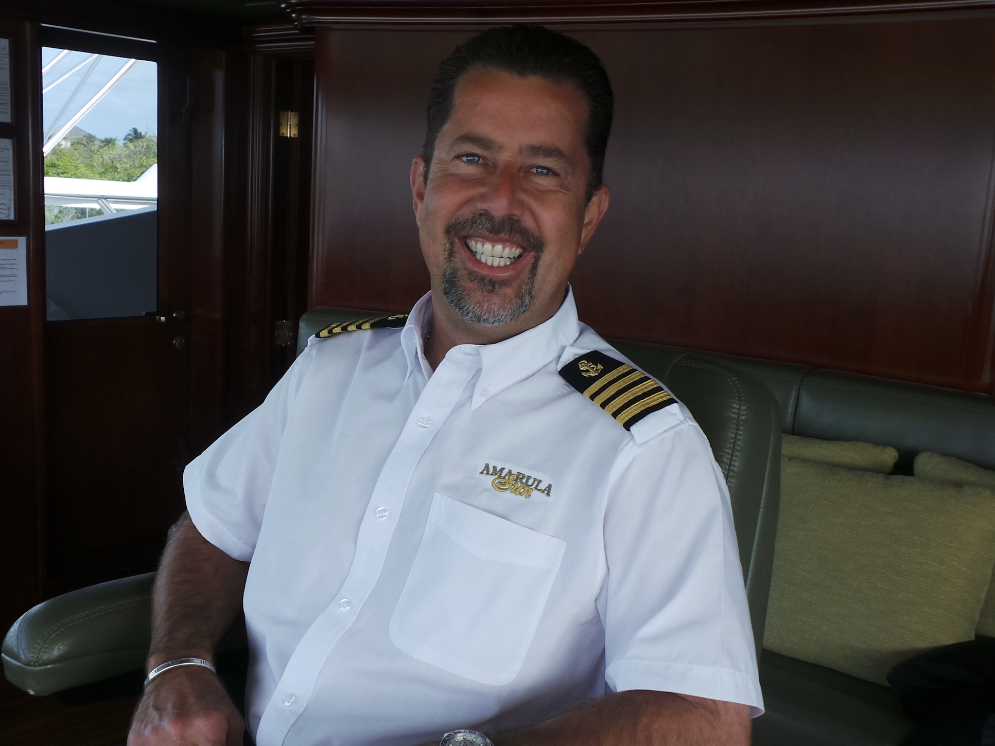 yacht captain smiling in the cabin