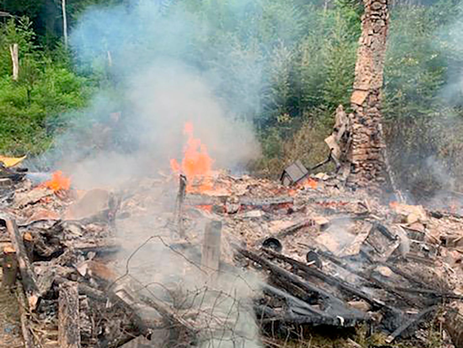 A fire in the woods that burned down a cabin.