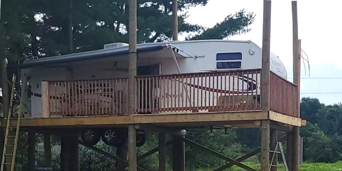 Images of a RV lofted on a platform in New Brunswick, Canada.