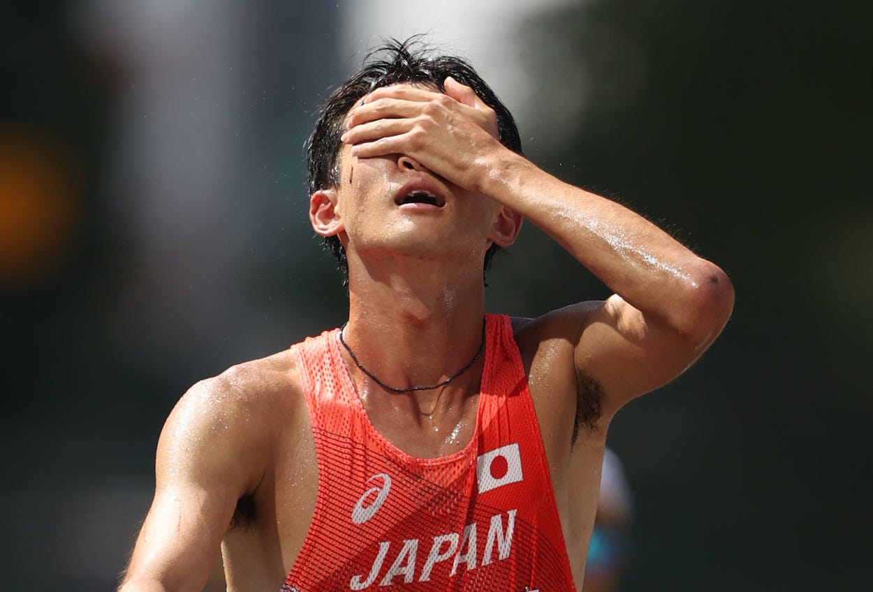 Masatora Kawano of Team Japan reacts after crossing the finish line in the men's 50-kilometer race walk.