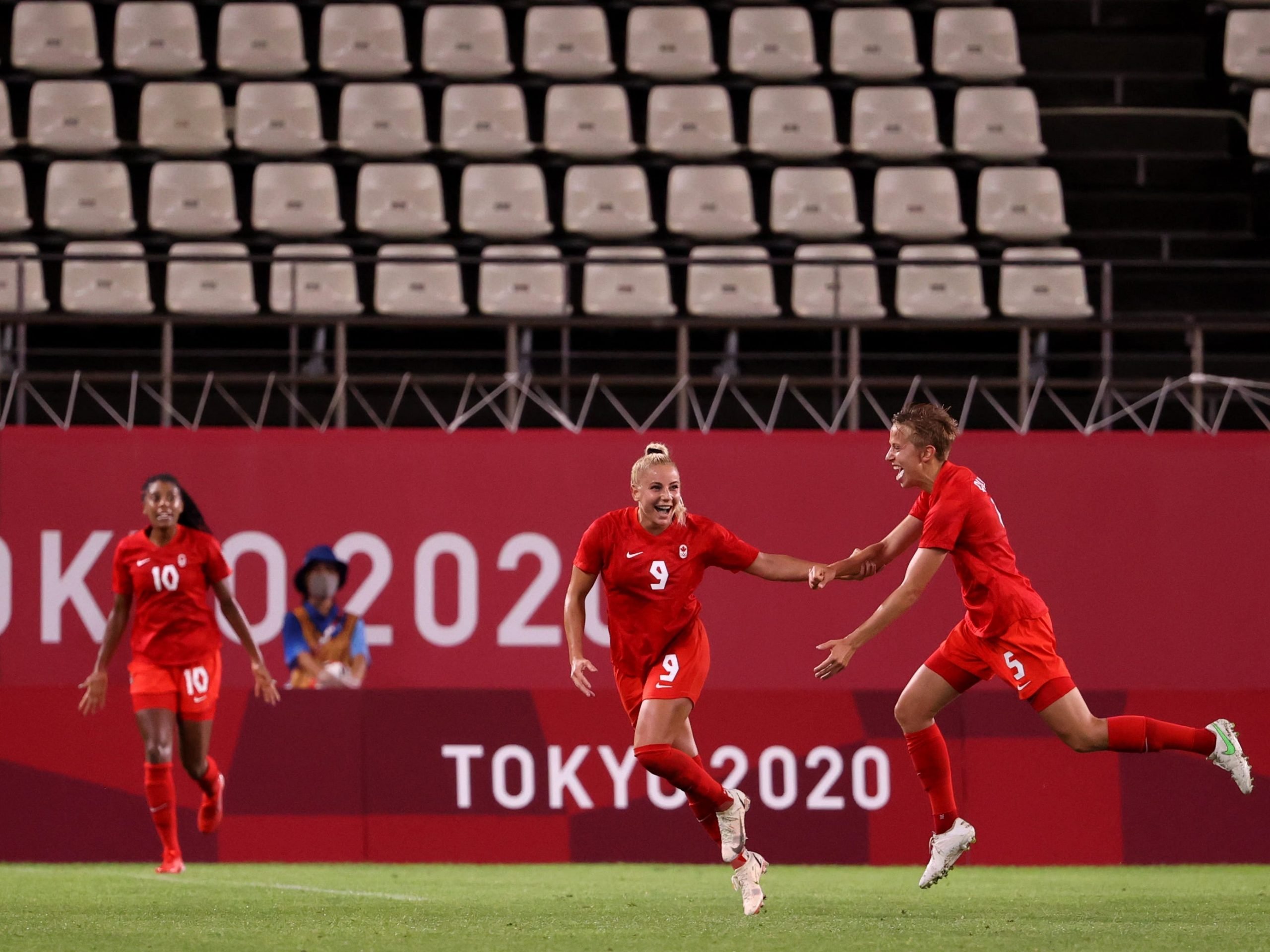 Adriana Leon #9 of Team Canada celebrates with teammate Quinn #5 after scoring their side's first goal during the Women's Group E match between Canada and Great Britain on day four of the Tokyo 2020 Olympic Games at Kashima Stadium on July 27, 2021 in Kashima, Ibaraki, Japan.