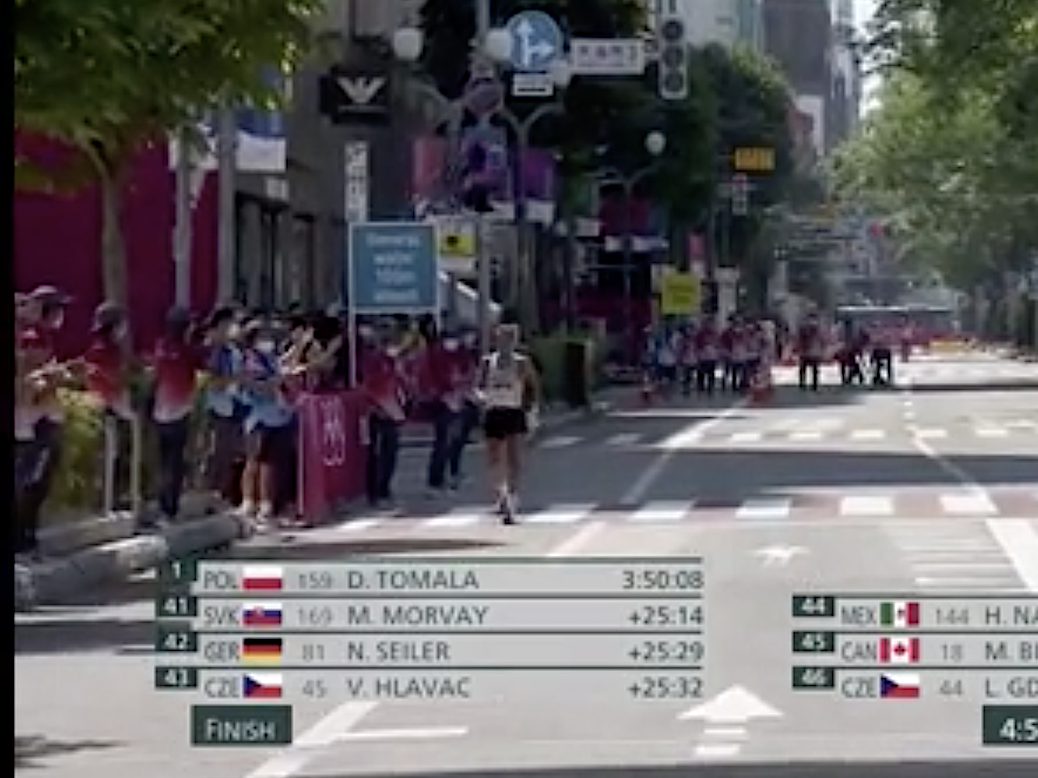 Claudio Villanueva Flores reaches the finish line at the 50km race walk amid applause