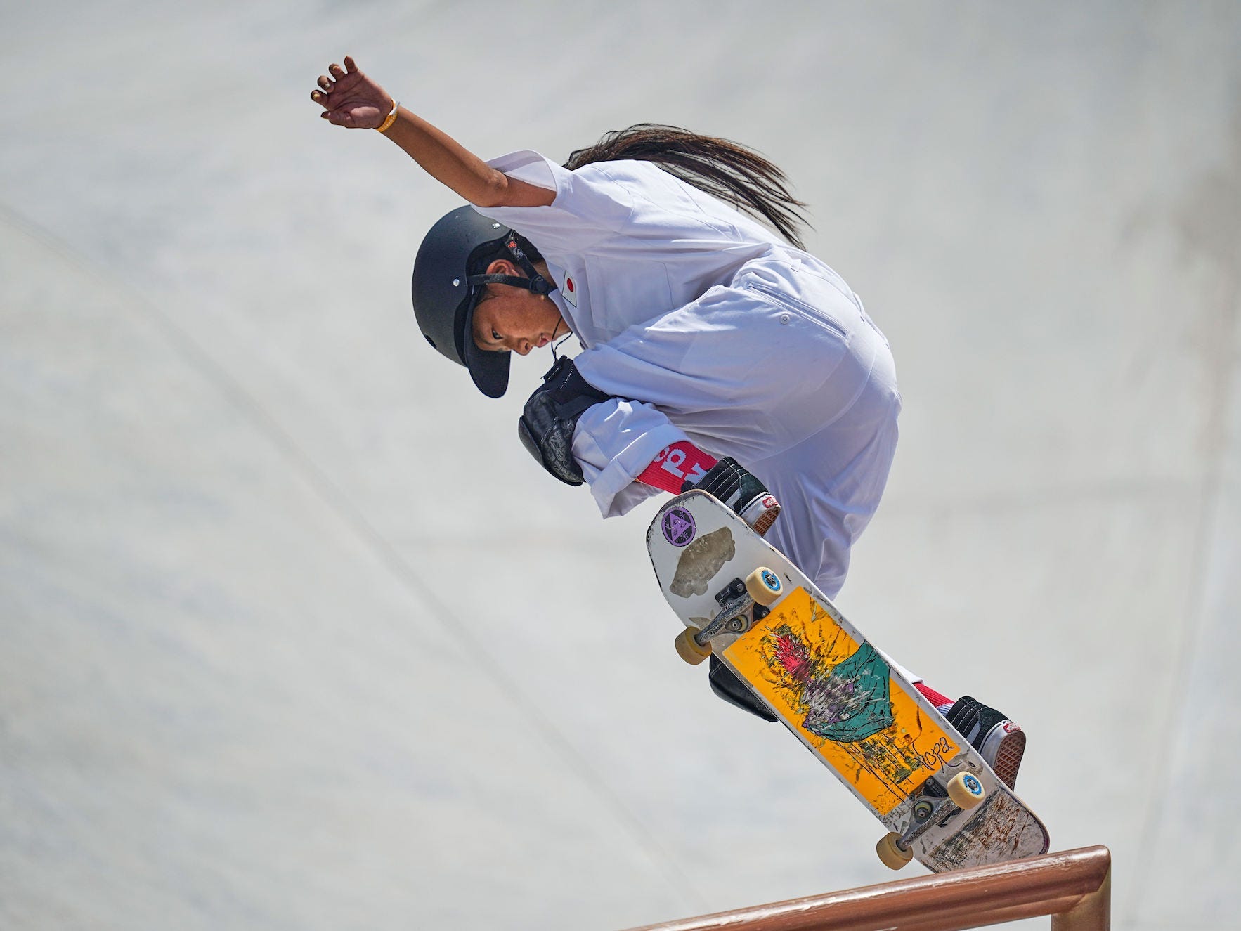 Kokona Hiraki doing a trick on a railing at the Tokyo 2020 Olympics games