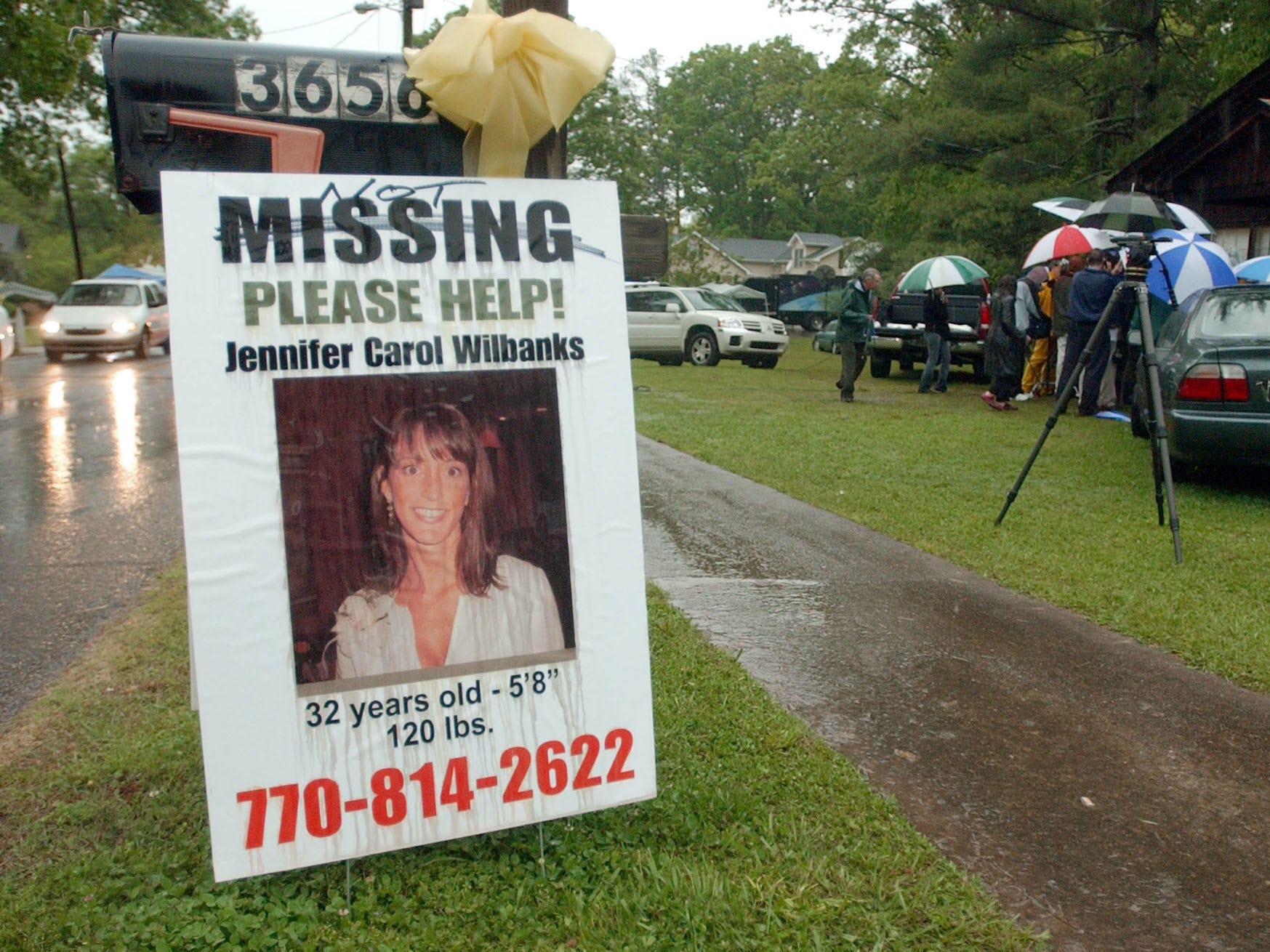 A photo of a missing person sign on the side of a highway.