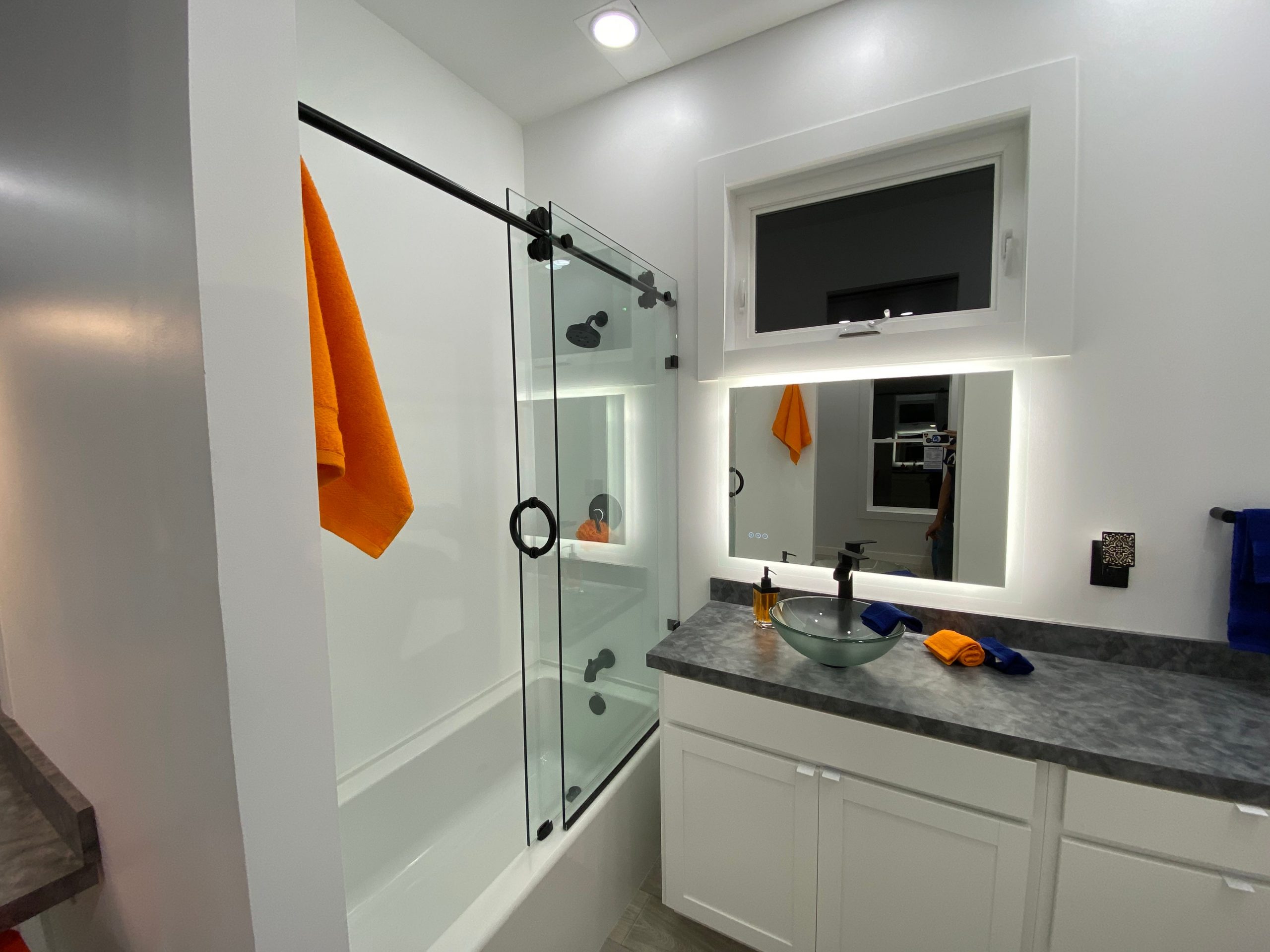 the bathroom with a shower, sink, mirror
