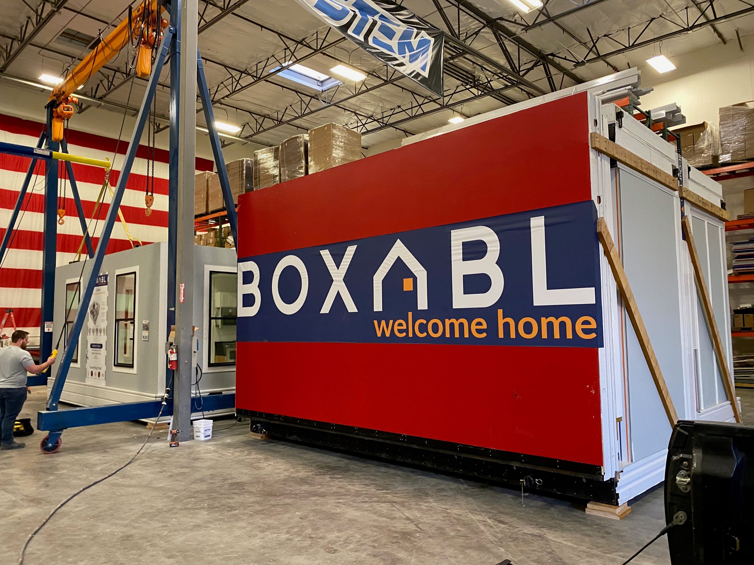 the Boxabl logo in a manfucaturing space