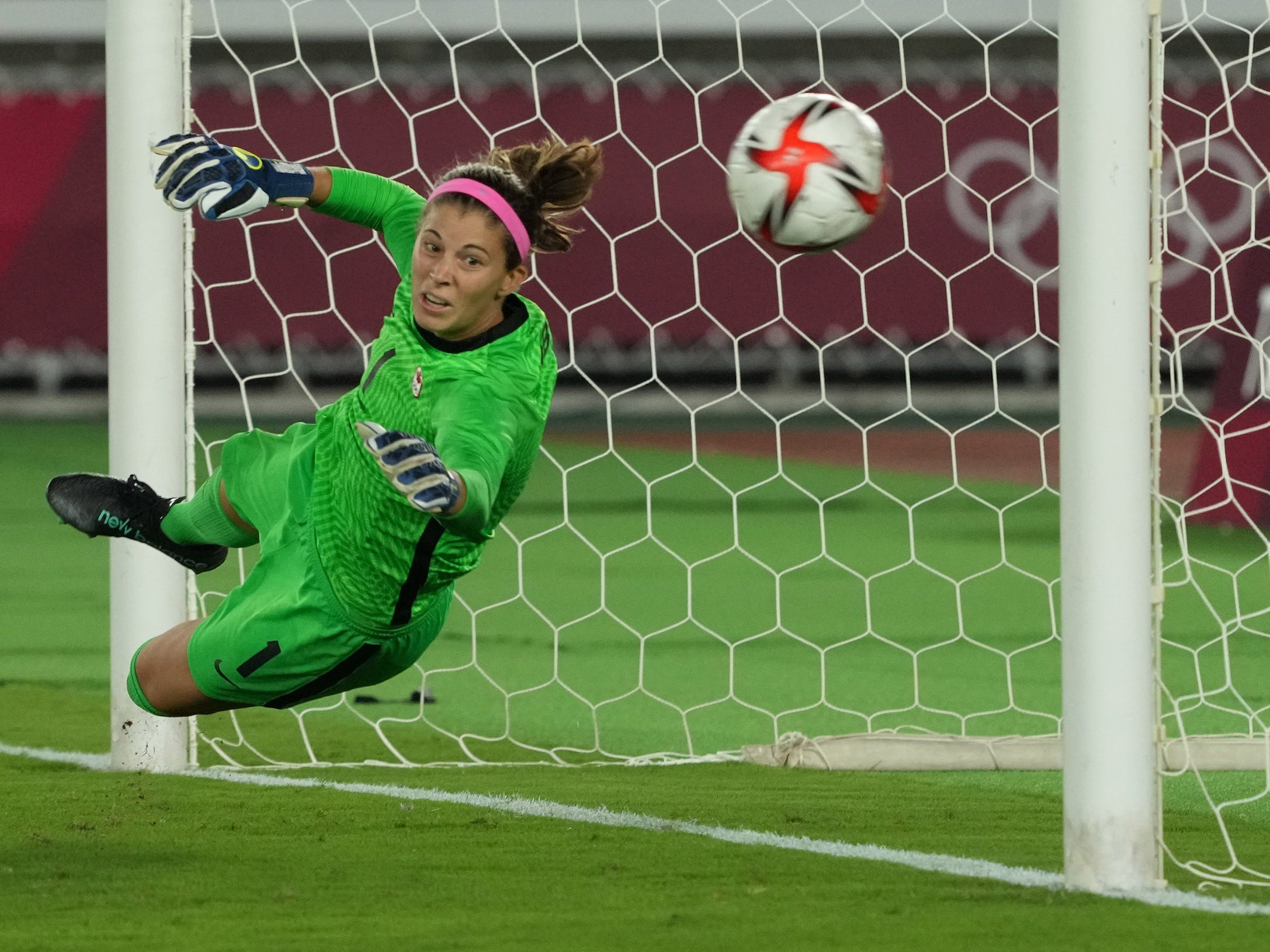 Canada's Stephanie Labbé saves a penalty kick.