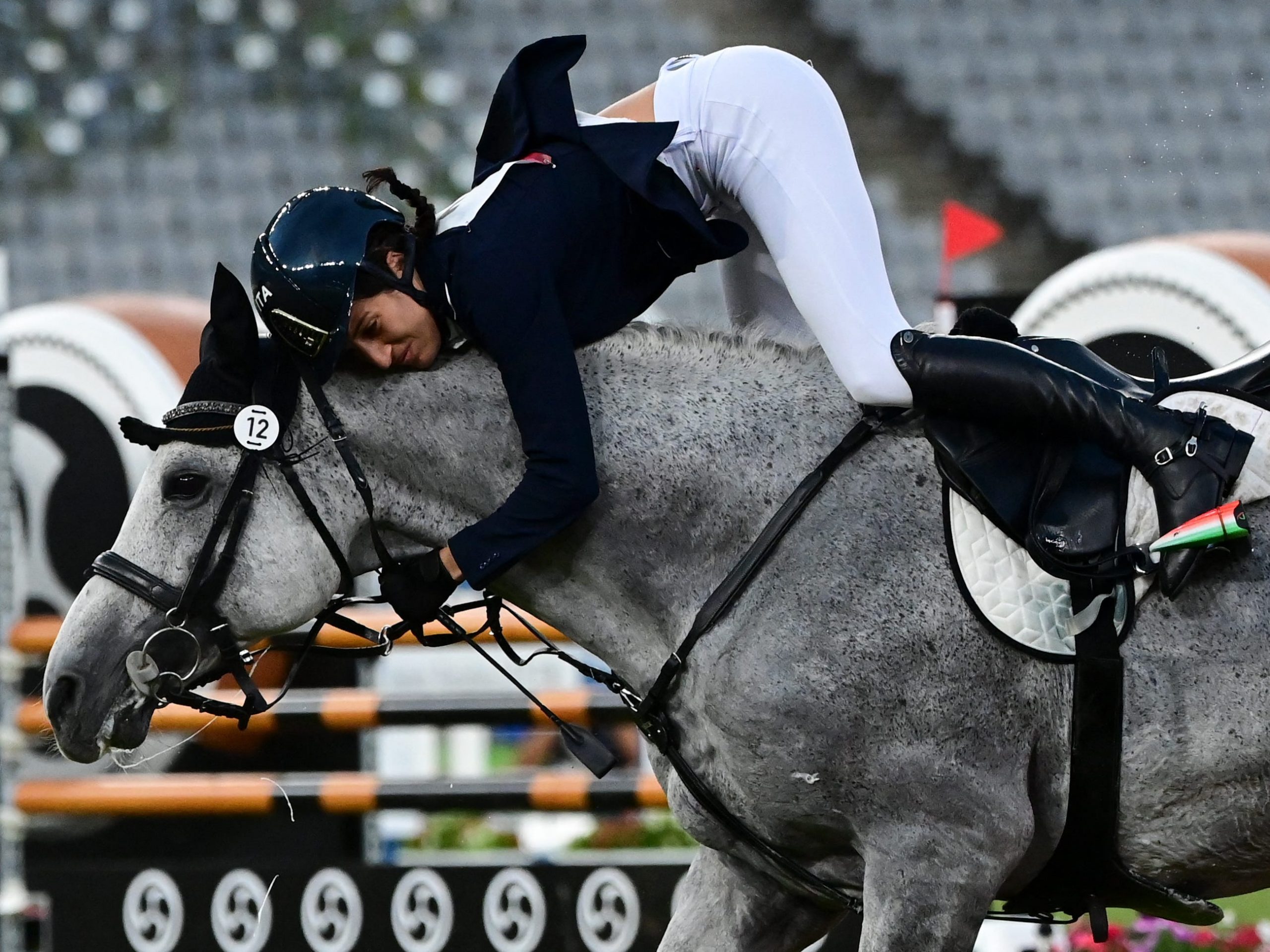 Elena Micheli of Italy is bucked from her horse during the showjumping portion of the Olympic modern pentathlon