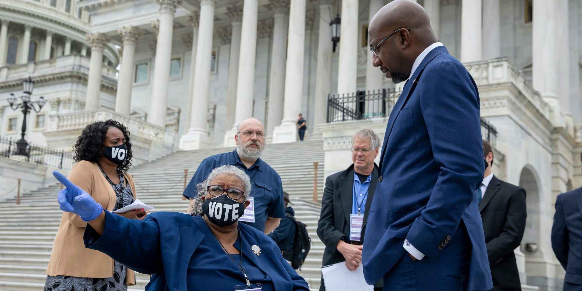 Sen. Raphael Warnock, D-Ga., meets with Angeline Sutton of Mississippi on Capitol Hill in Washington, Tuesday, Aug. 3, 2021.