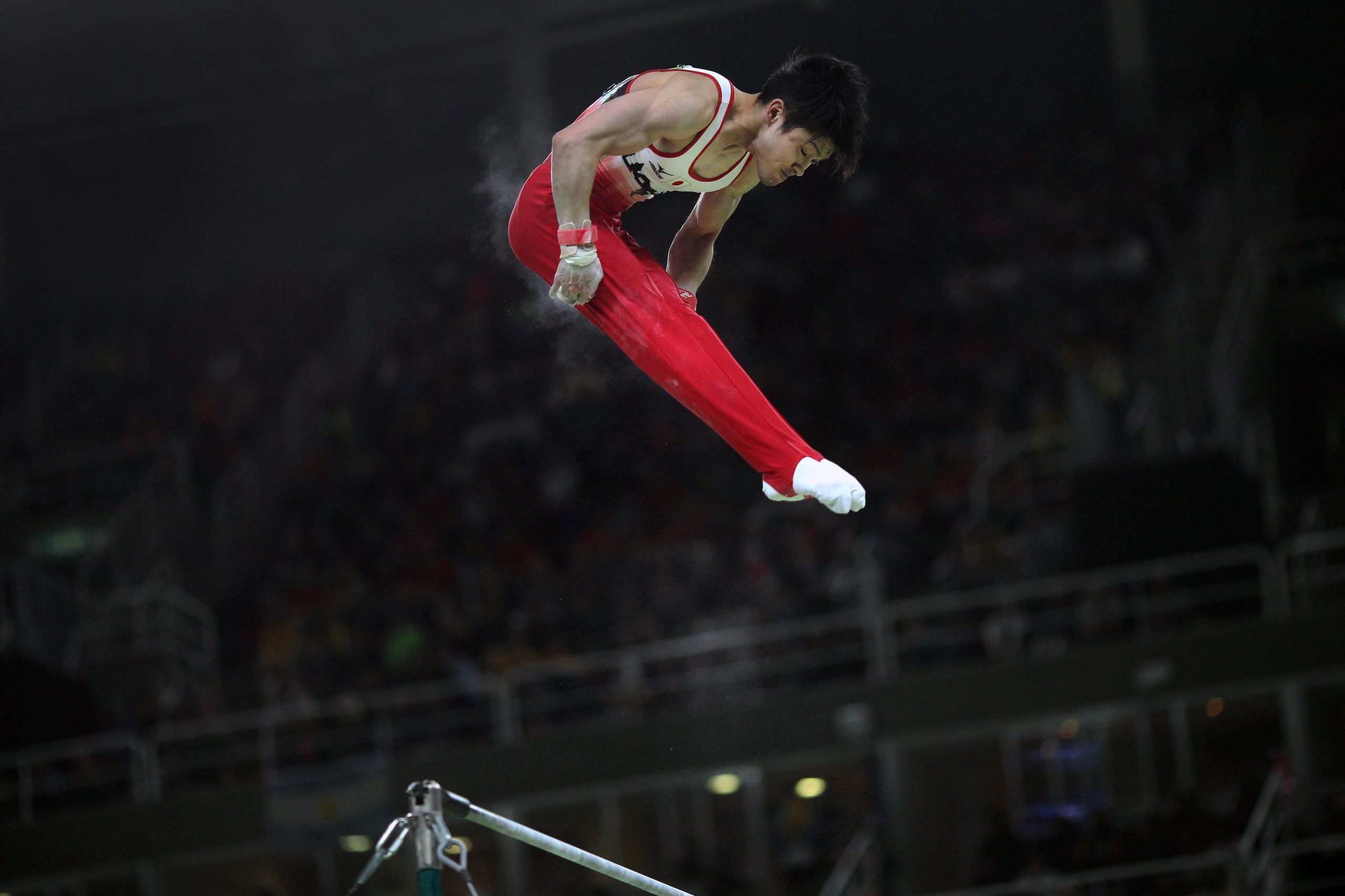 A gymnast exhibiting beautiful form in the air.