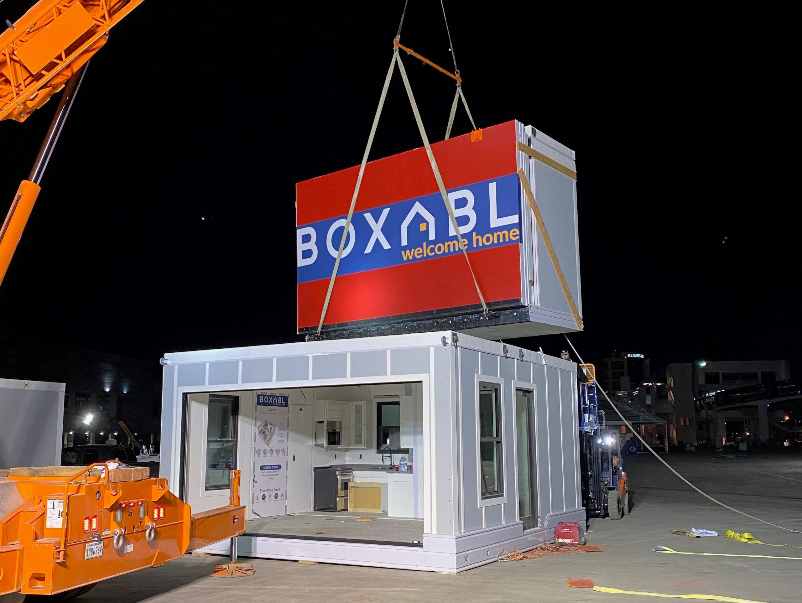 Casita being set up outside with a Boxabl unit being lowered down with a crane.