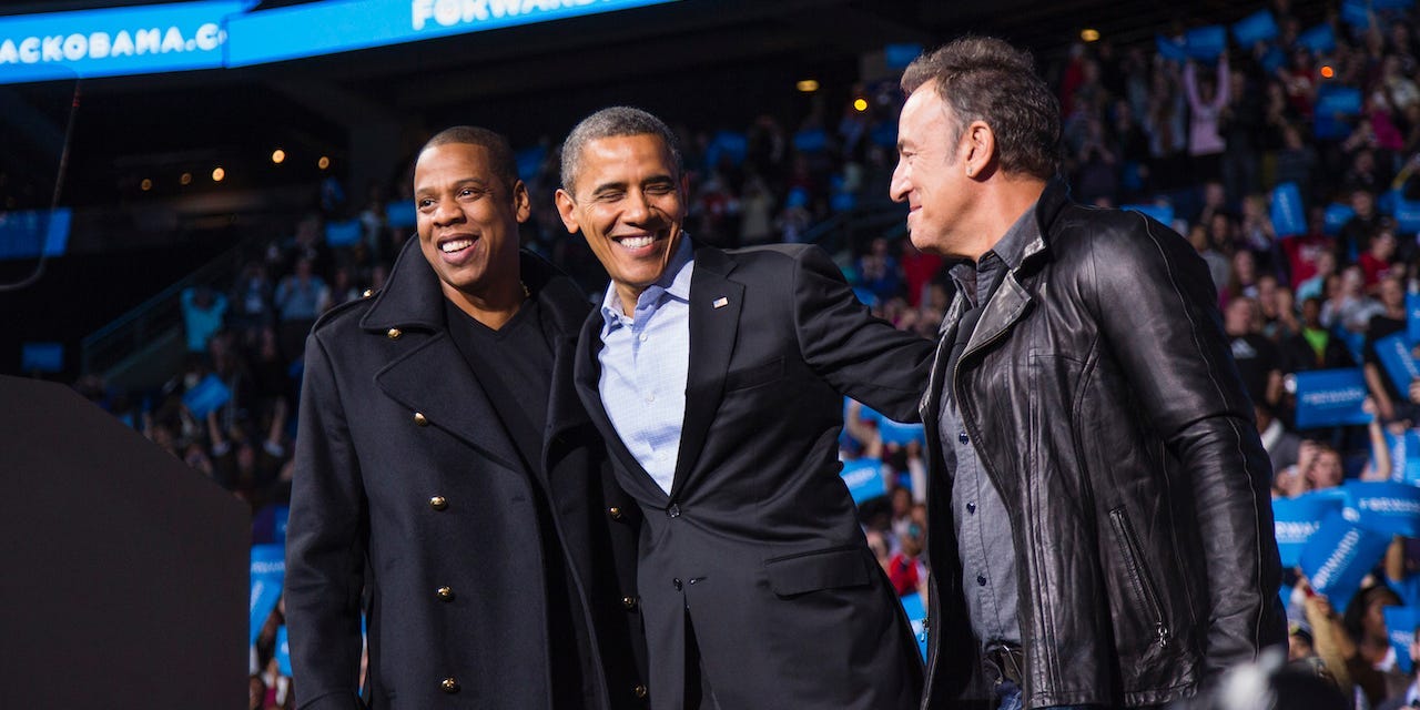 Barack Obama stands on stage with rapper Jay-Z and musician Bruce Springsteen at an election campaign rally in Columbus, Ohio in 2012.