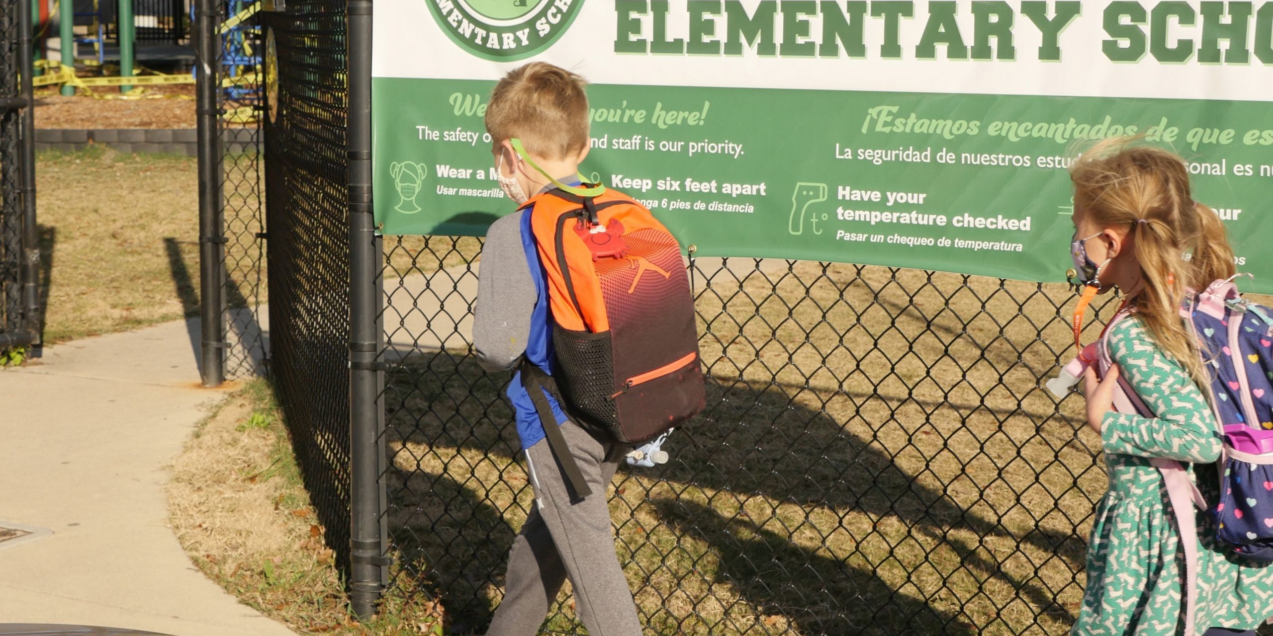 Students walk into a school