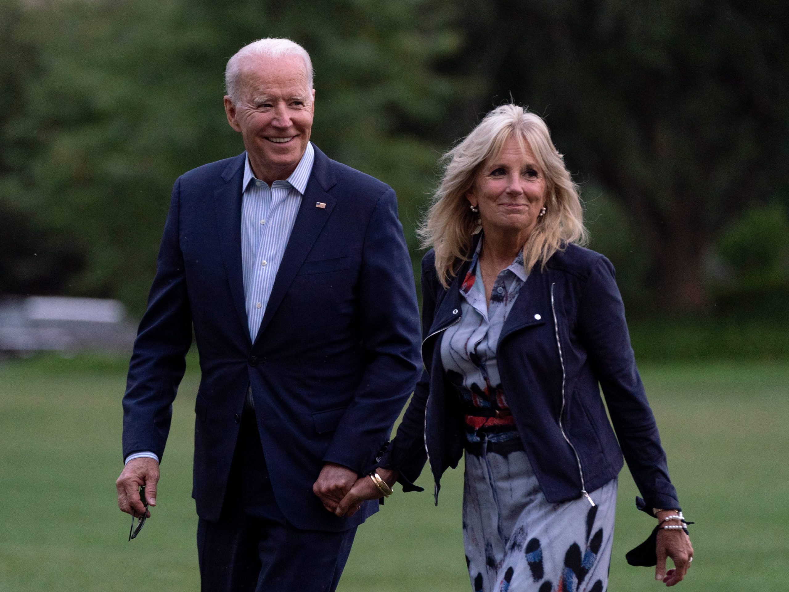 President Joe Biden and first lady Jill Biden walk on the South Lawn of the White House after stepping off Marine One, Sunday, July 18, 2021, in Washington. The Bidens are returning to Washington after spending the weekend at Camp David.