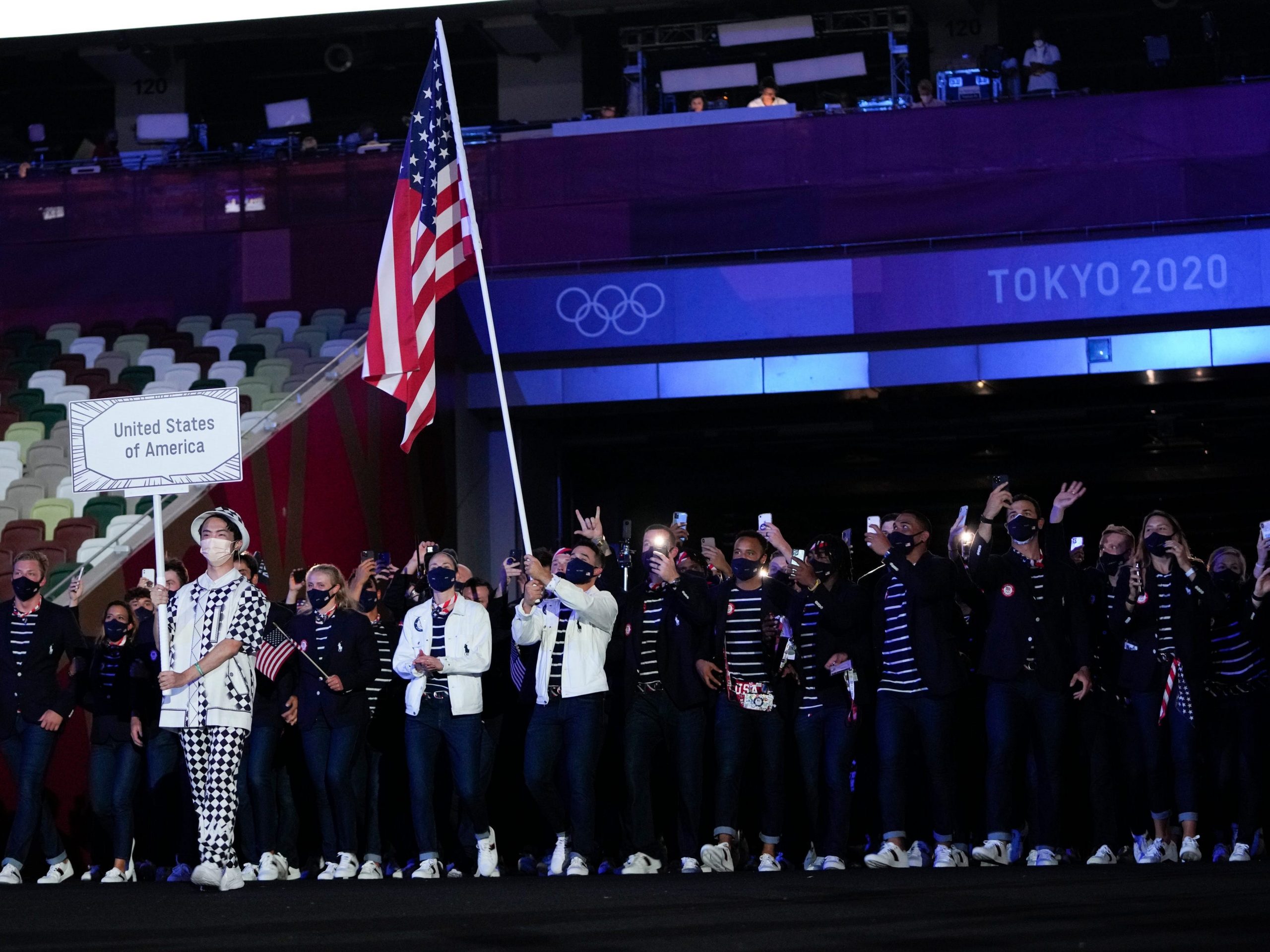 Sue Bird and Eddy Alvarez, of the United States of America, carry their country's flag during the opening ceremony in the Olympic Stadium at the 2020 Summer Olympics, Friday, July 23, 2021, in Tokyo, Japan.
