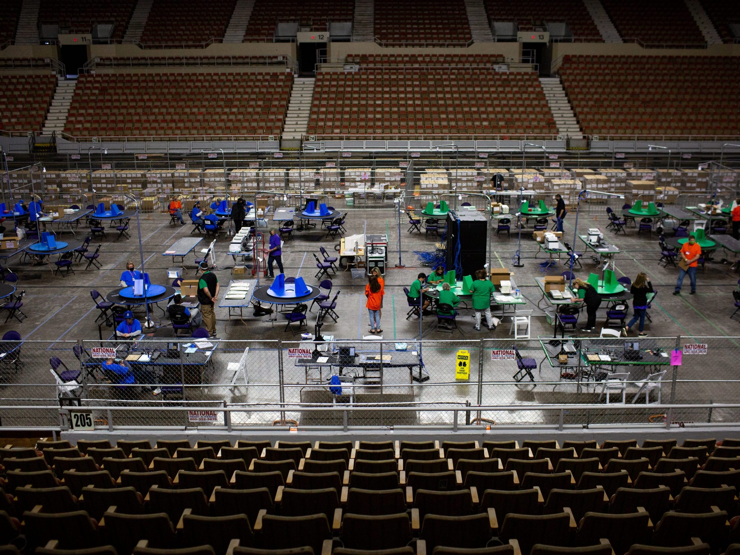 Contractors working for Cyber Ninjas, who was hired by the Arizona State Senate, examine and recount ballots from the 2020 general election on May 3, 2021 in Phoenix, Arizona.