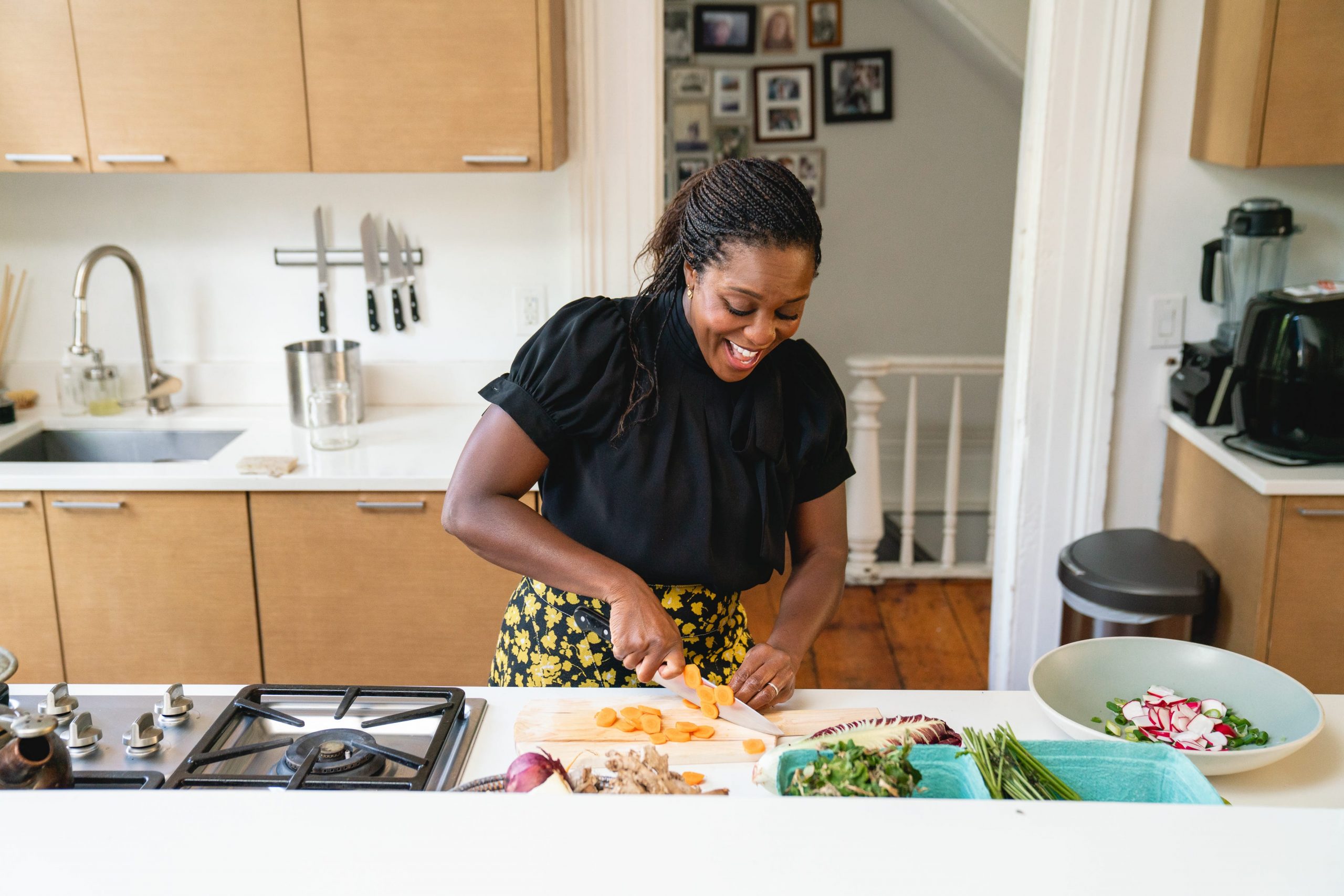Maya Feller chopping vegetables in her kitchen