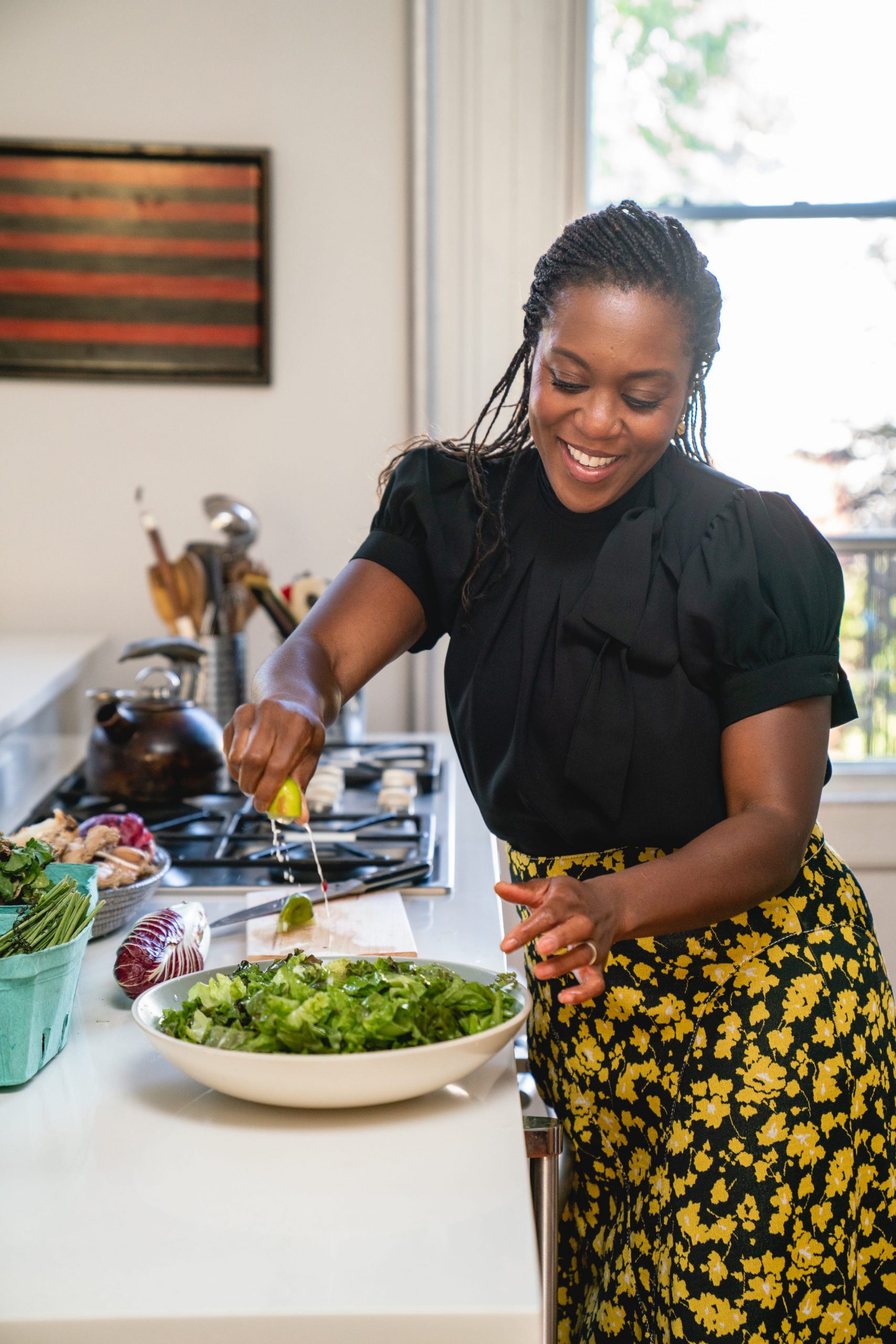 Dietician Maya Feller squeezing lime juice on a salad.
