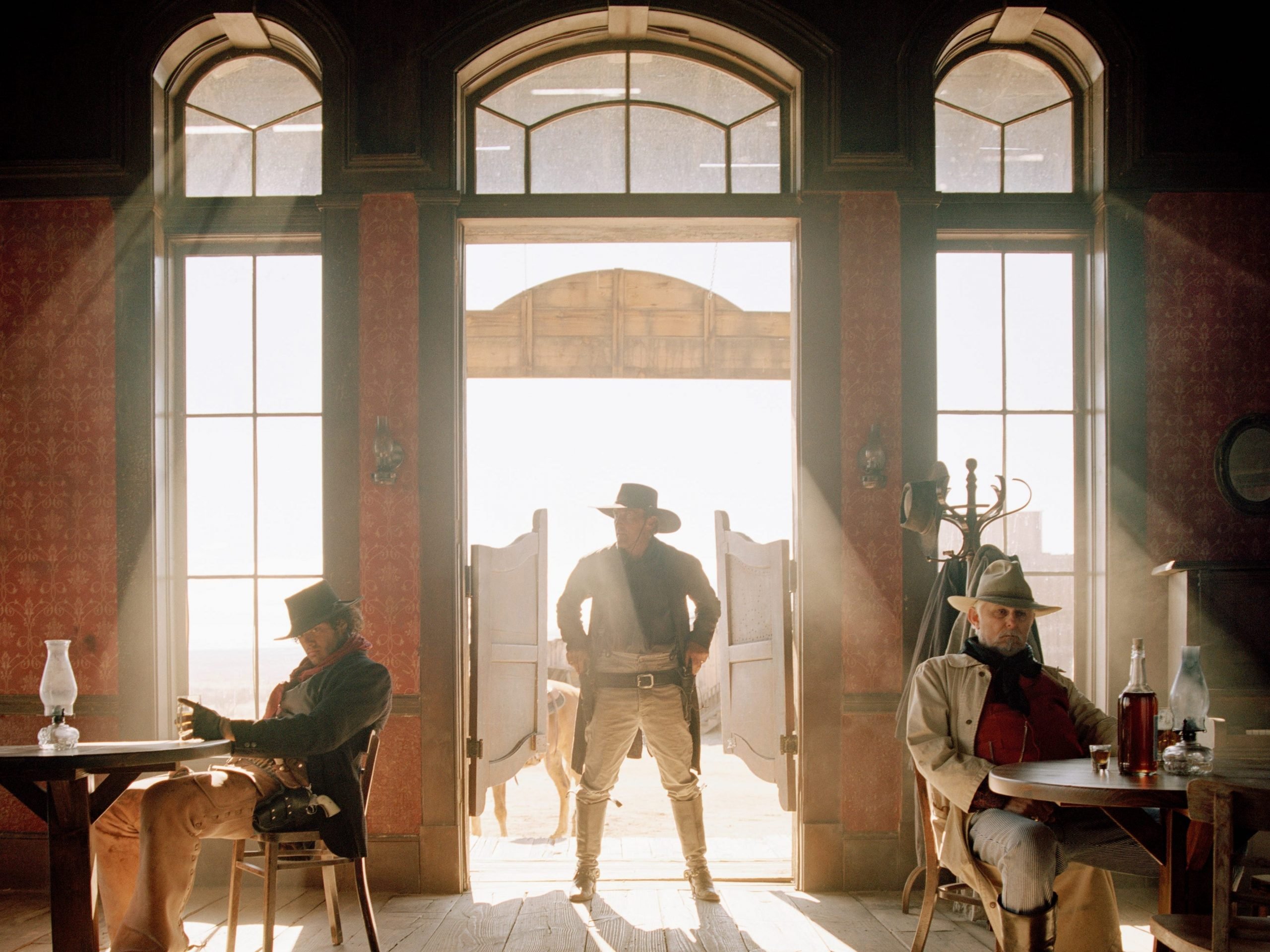 wild west imagery with a cowboy entering a saloon